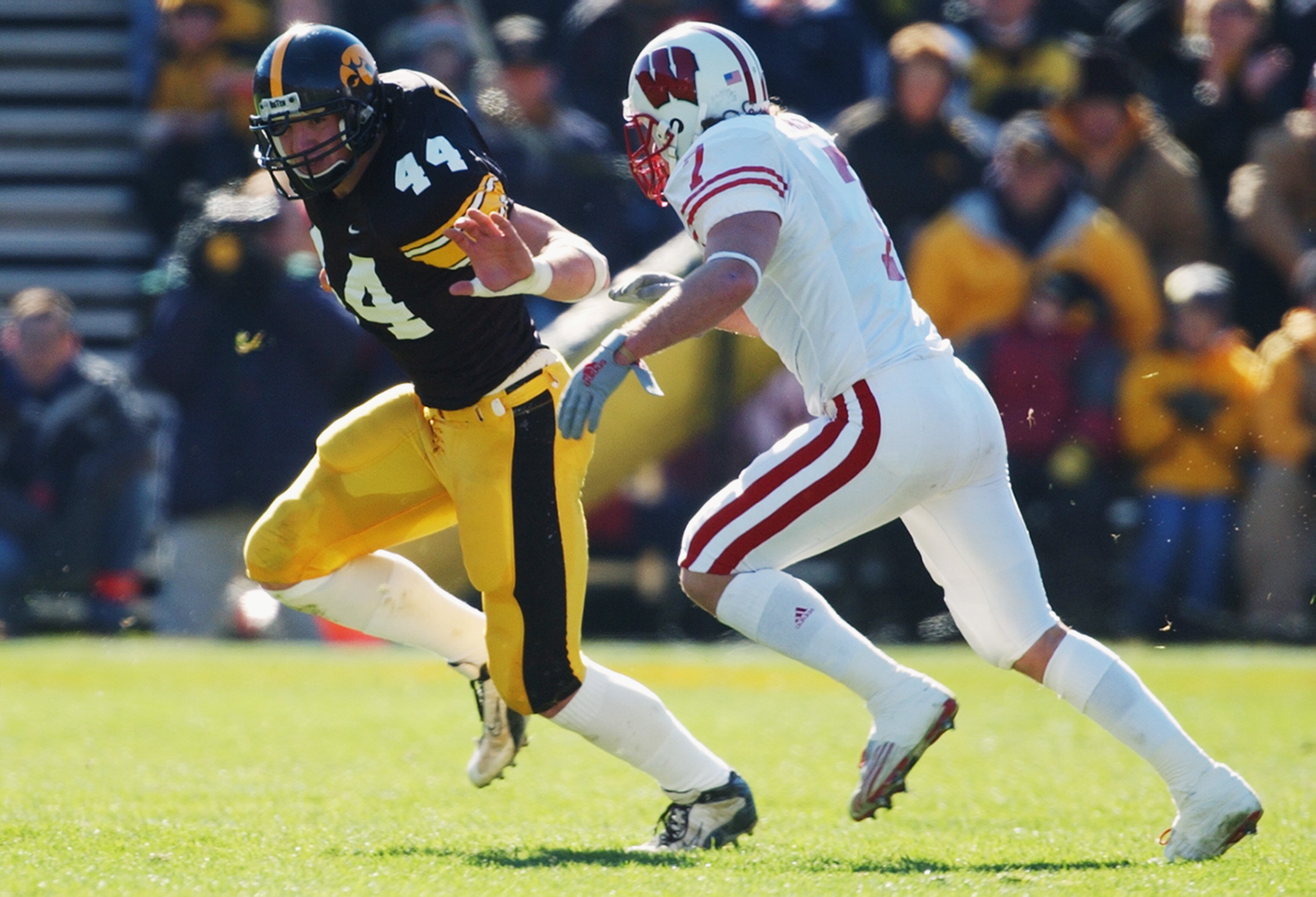 IOWA CITY, IOWA - NOVEMBER 2:  Defensive back Ryan Aiello #7 of the Wisconsin Badgers chases tight end Dallas Clark #44 of the Iowa Hawkeyes during the Big 10 Conference football game at Kinnick Stadium on November 2, 2002 in Iowa City, Iowa.  The Hawkeye