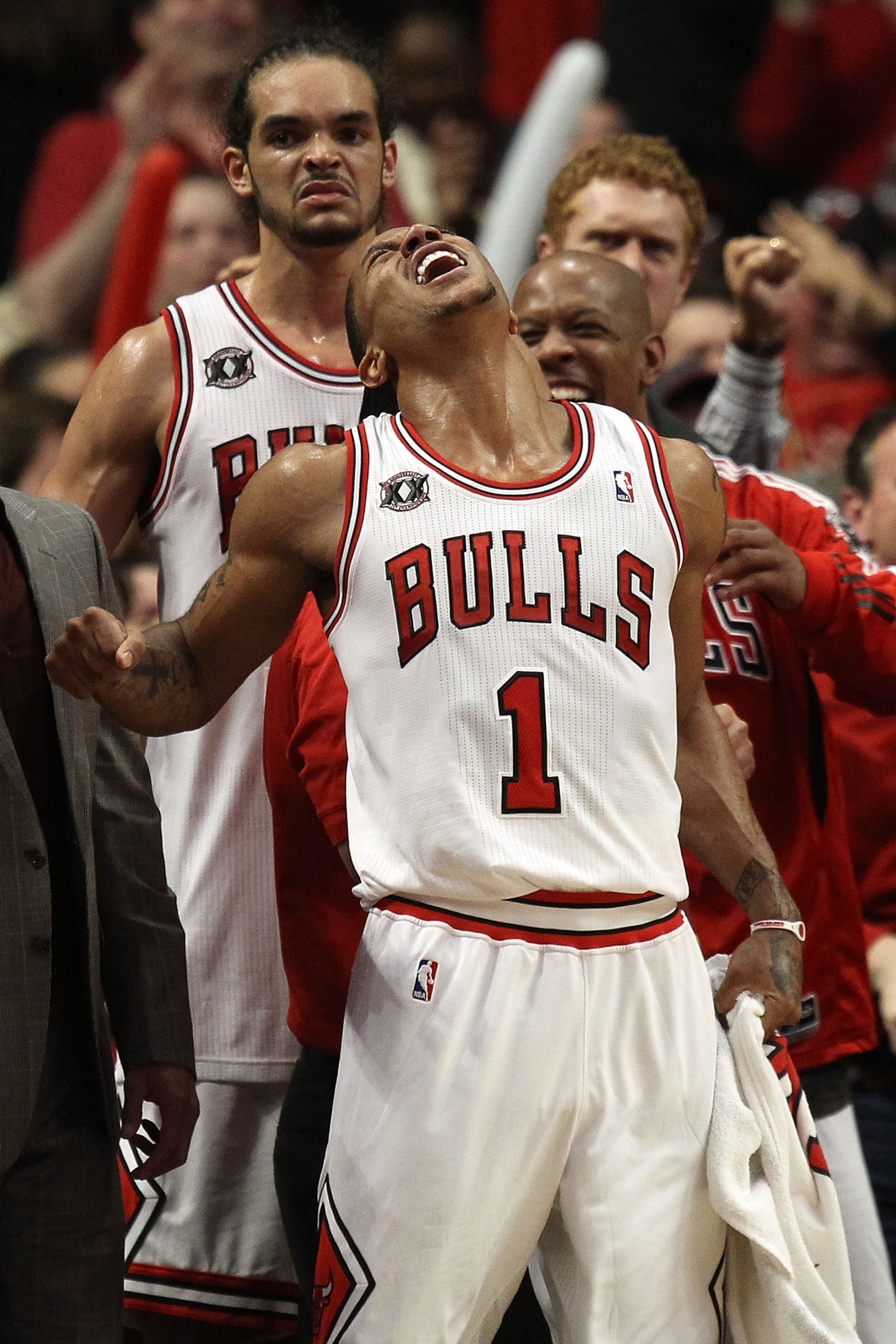 CHICAGO, IL - MAY 15:  (L-R) Joakim Noah #13, Derrick Rose #1 and Keith Bogans #6 of the Chicago Bulls celebrate late in the fourth quarter against the Miami Heat in Game One of the Eastern Conference Finals during the 2011 NBA Playoffs on May 15, 2011 at