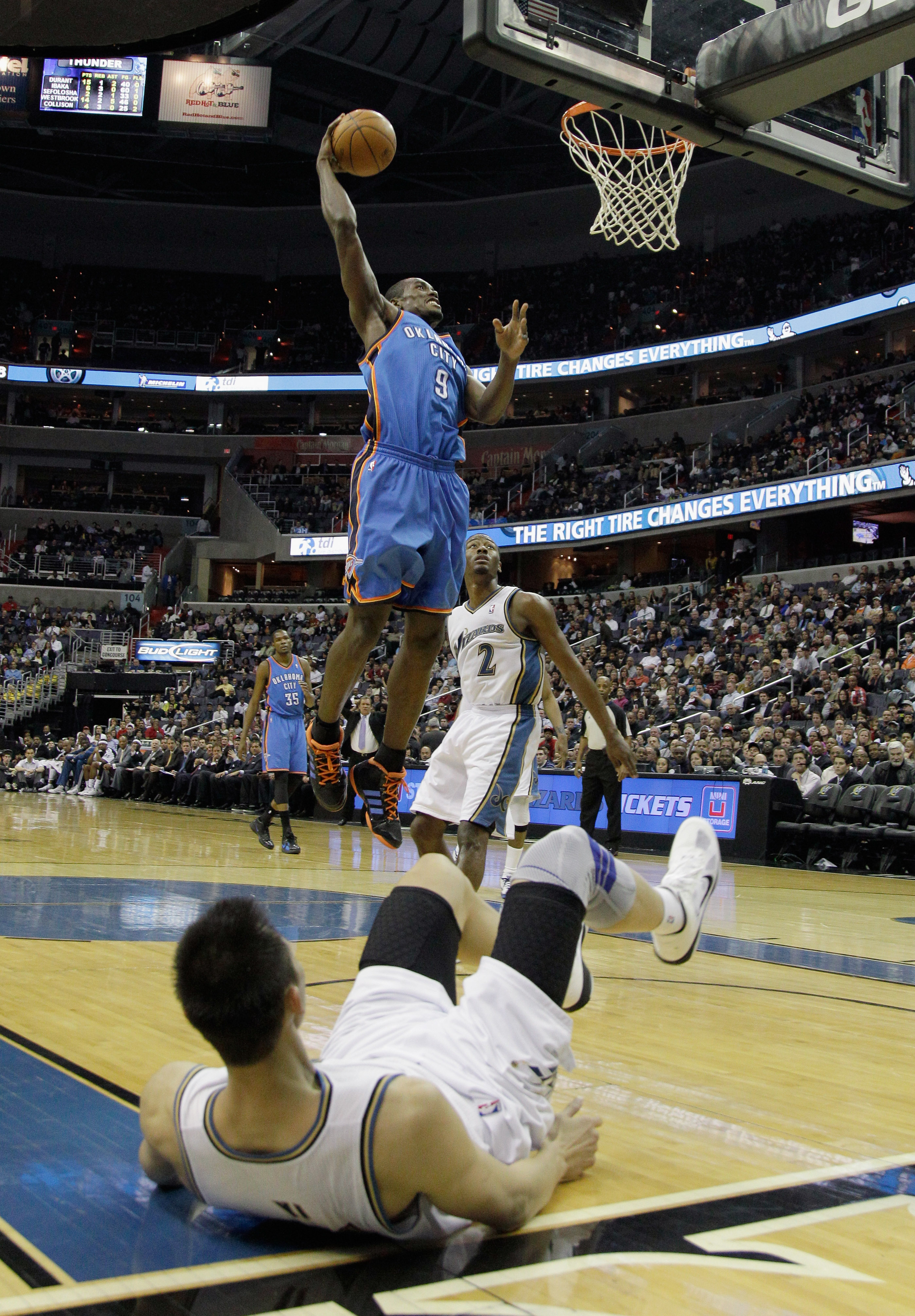 WASHINGTON, DC - MARCH 14:  Serge Ibaka #9 of the Oklahoma City Thunder dunks over Yi Jianlian #31 of the Washington Wizards during the first half at the Verizon Center on March 14, 2011 in Washington, DC. NOTE TO USER: User expressly acknowledges and agr