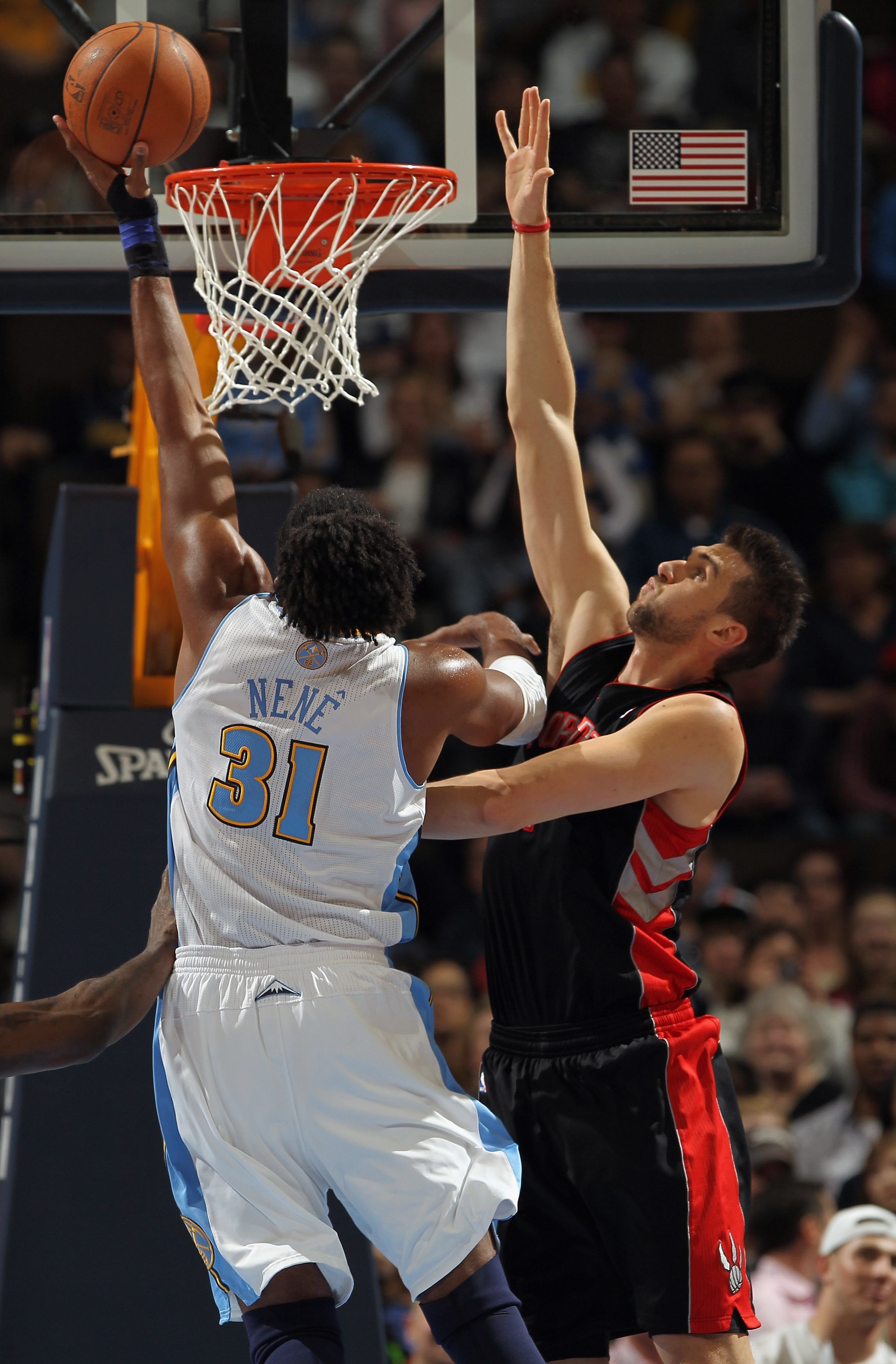 DENVER, CO - MARCH 21:  Nene #31 of the Denver Nuggets takes a shot against the defense of Andrea Bargnani #7 of the Toronto Raptors at the Pepsi Center on March 21, 2011 in Denver, Colorado. NOTE TO USER: User expressly acknowledges and agrees that, by d