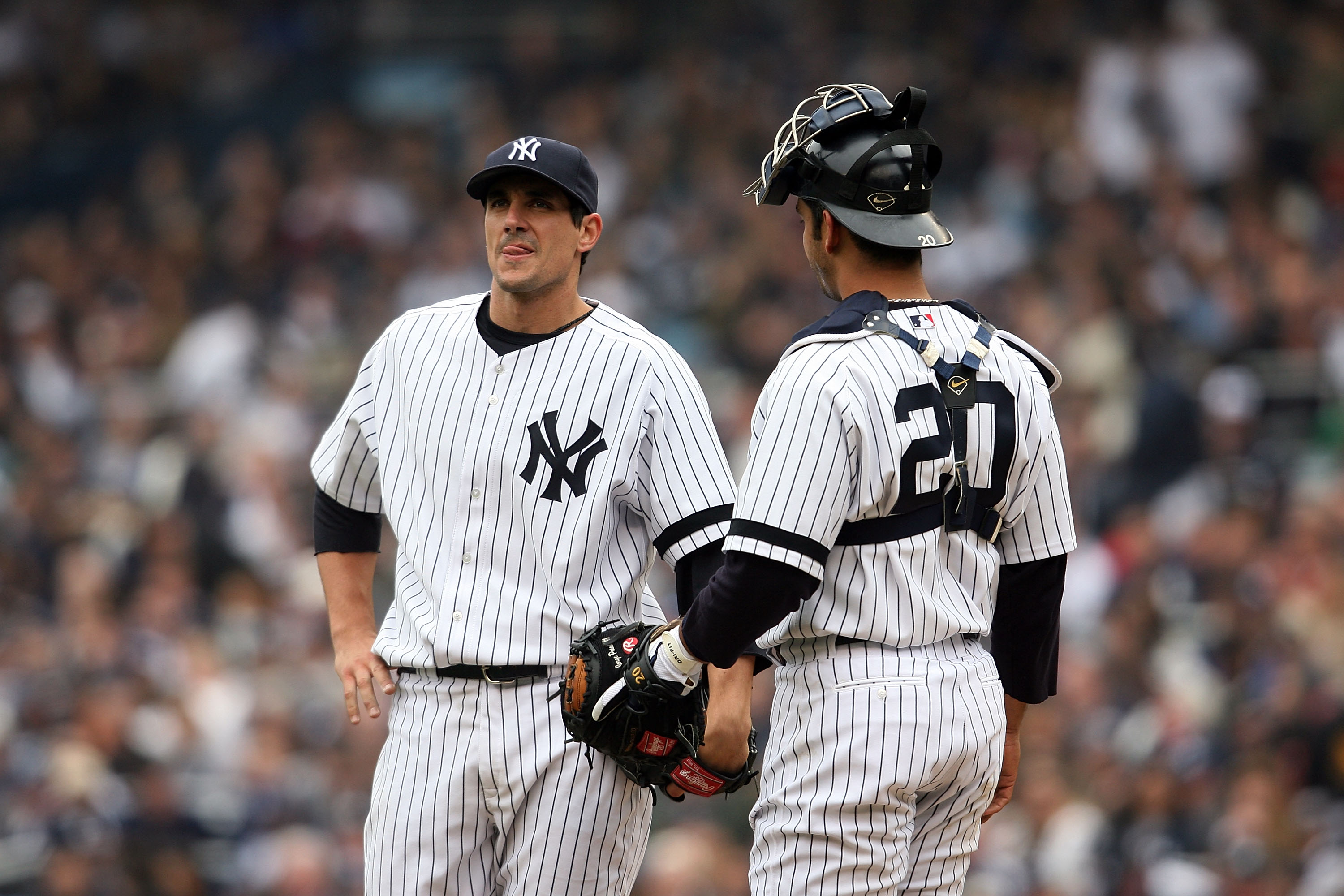 NEW YORK - APRIL 02:  Starting pitcher Carl Pavano #45 of the New York Yankees talks with catcher Jorge Posada #20 on the mound after pitching against the Tampa Bay Devil Rays during their Opening Day game at Yankee Stadium April 2, 2007 in the Bronx boro