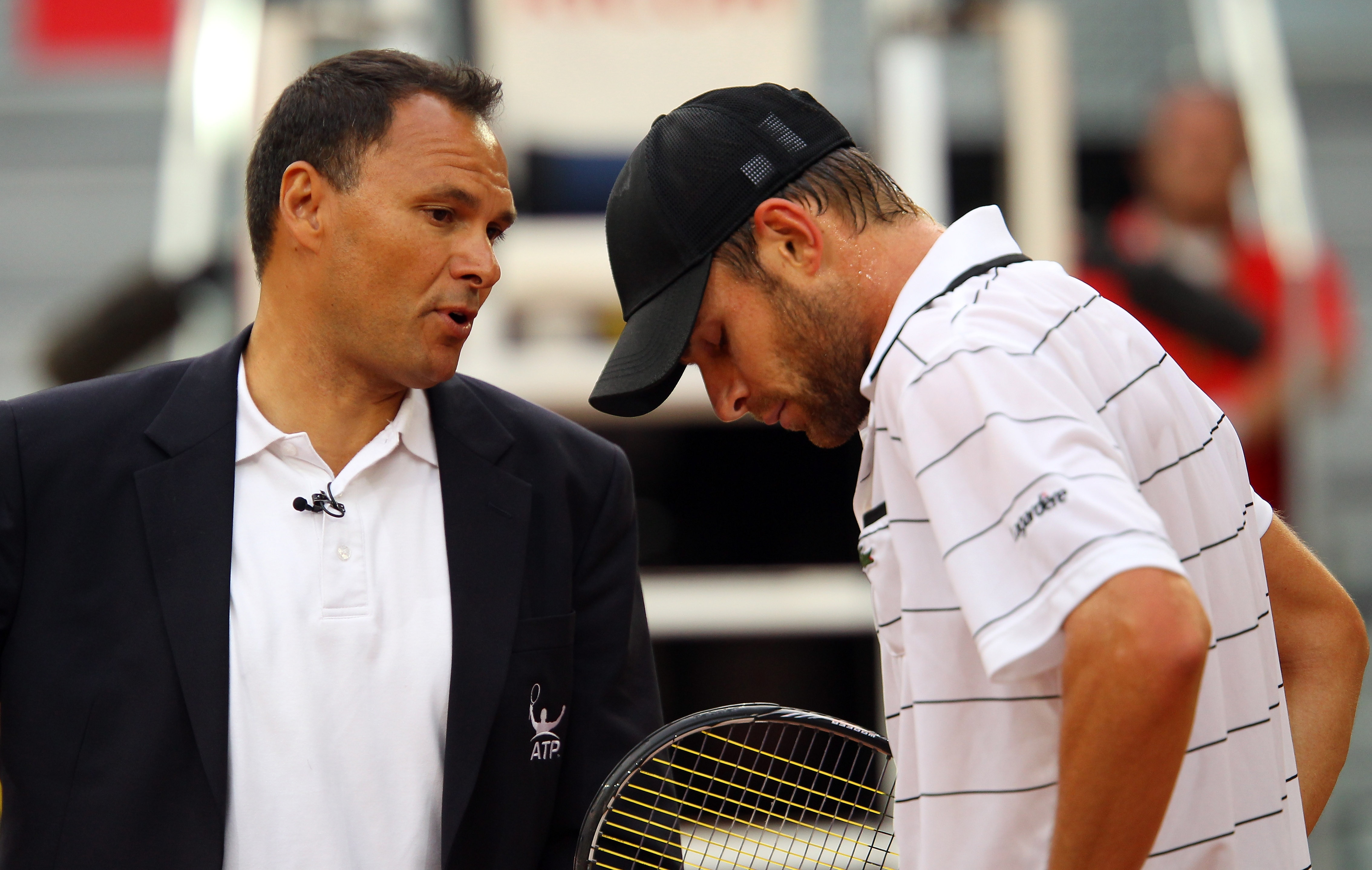 MADRID, SPAIN - MAY 02:  Andy Roddick of USA disscusses a line call with umpire Mohamed Lahyani in his match against Flavio Cipolla of Italy during day three of the Mutua Madrilena Madrid Open Tennis on May 2, 2011 in Madrid, Spain.  (Photo by Julian Finn