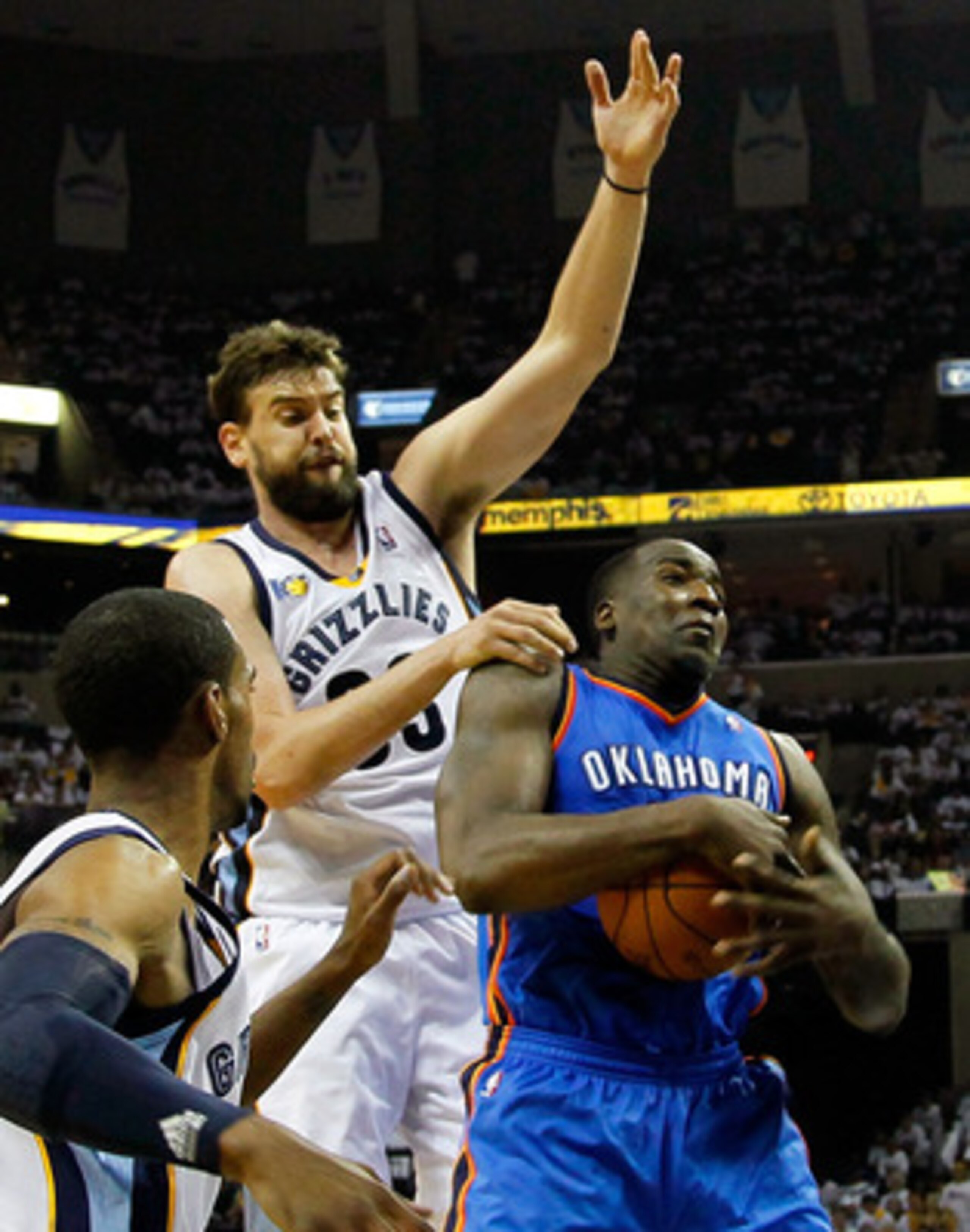 MEMPHIS, TN - MAY 13:  Kendrick Perkins #5 of the Oklahoma City Thunder grabs a rebound against Marc Gasol #33 and Mike Conley #11 of the Memphis Grizzlies in Game Six of the Western Conference Semifinals in the 2011 NBA Playoffs at FedExForum on May 13, 