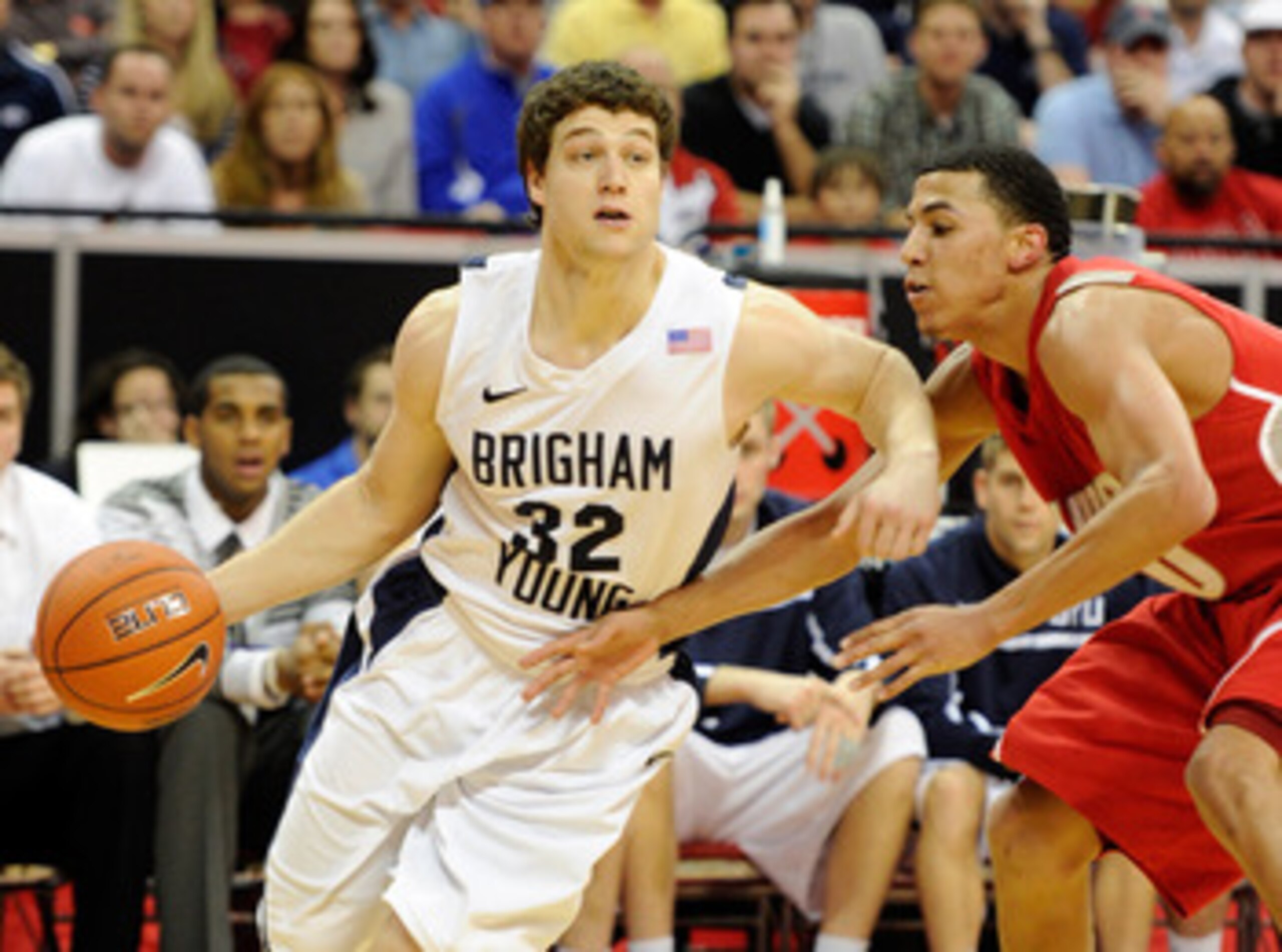 LAS VEGAS, NV - MARCH 11:  Jimmer Fredette #32 of the Brigham Young University Cougars drives against Kendall Williams #10 of the New Mexico Lobos during a semifinal game of the Conoco Mountain West Conference Basketball tournament at the Thomas & Mack Ce