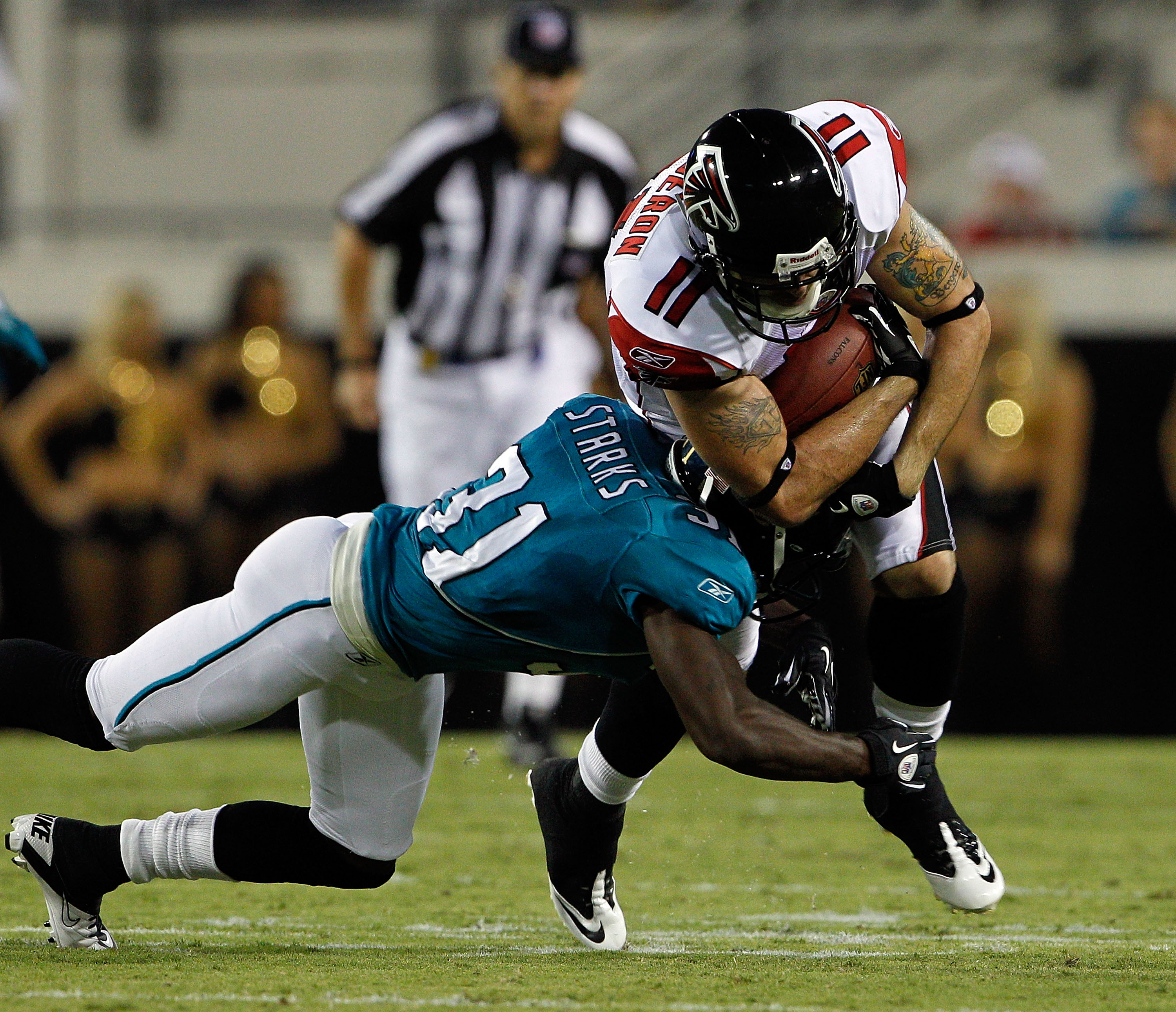 JACKSONVILLE, FL - SEPTEMBER 02:  Troy Bergeron #11 of the Atlanta Falcons is tackled by Scott Starks #31 of the Jacksonville Jaguars during a preseason game at EverBank Field on September 2, 2010 in Jacksonville, Florida.  (Photo by Sam Greenwood/Getty I