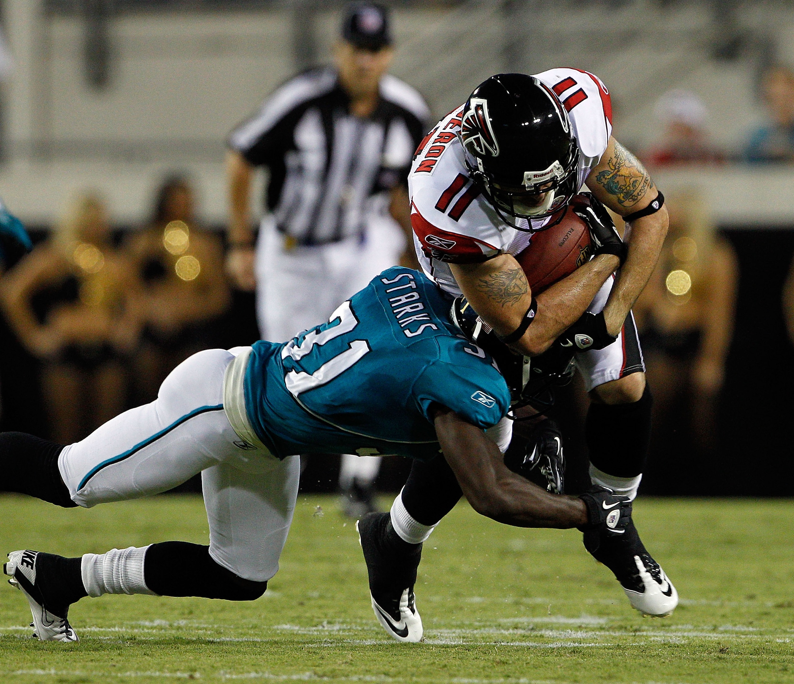 JACKSONVILLE, FL - SEPTEMBER 02:  Troy Bergeron #11 of the Atlanta Falcons is tackled by Scott Starks #31 of the Jacksonville Jaguars during a preseason game at EverBank Field on September 2, 2010 in Jacksonville, Florida.  (Photo by Sam Greenwood/Getty I