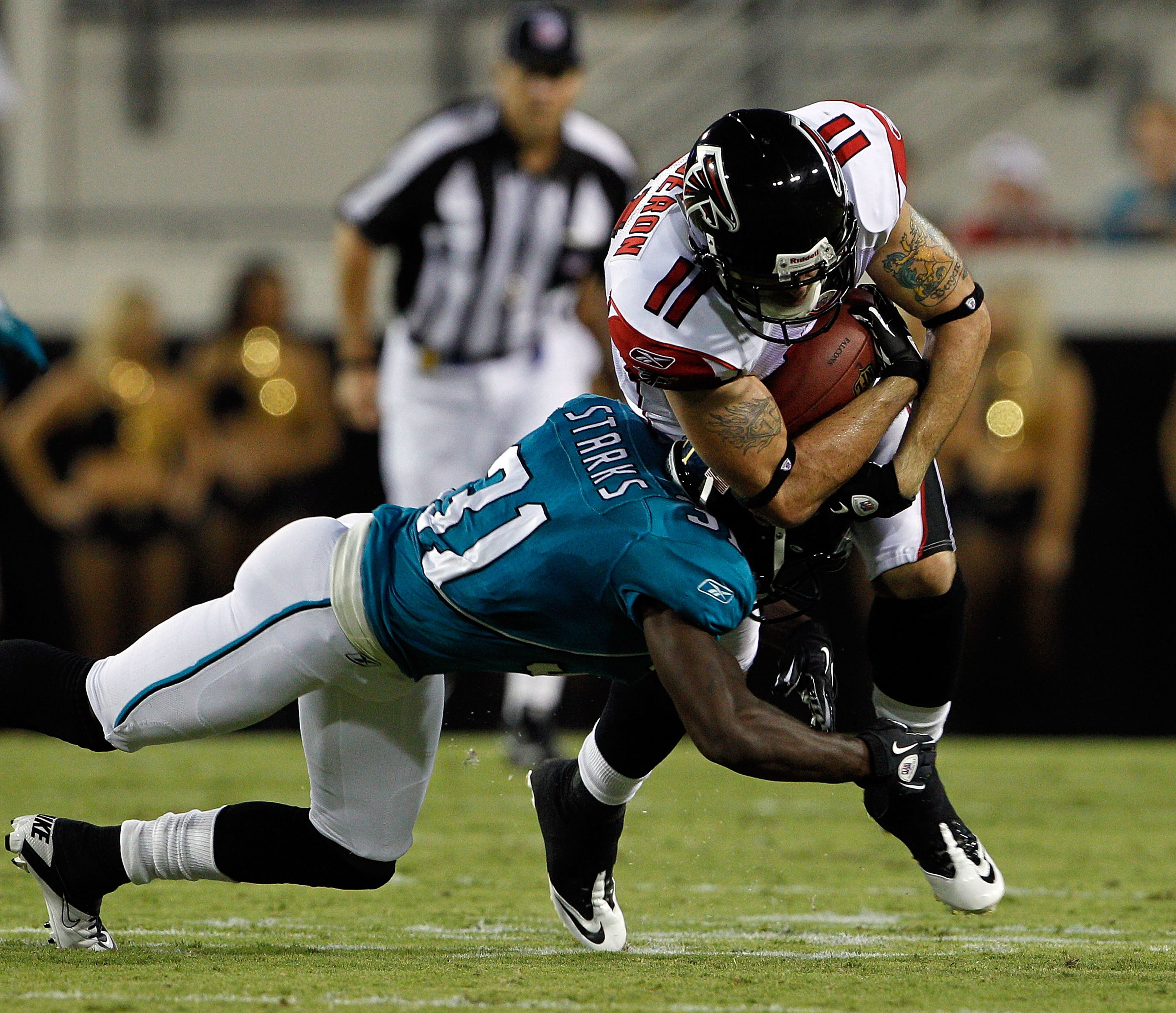JACKSONVILLE, FL - SEPTEMBER 02:  Troy Bergeron #11 of the Atlanta Falcons is tackled by Scott Starks #31 of the Jacksonville Jaguars during a preseason game at EverBank Field on September 2, 2010 in Jacksonville, Florida.  (Photo by Sam Greenwood/Getty I