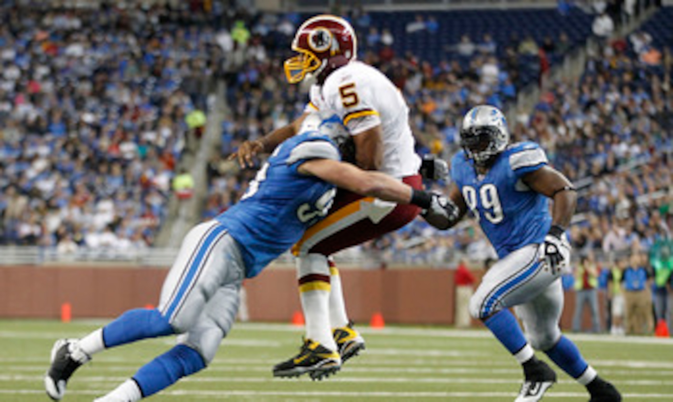 DETROIT - OCTOBER 31: Kyle Vanden Bosch #93 of the Detroit Lions hits Donovan McNabb #5 of the Washington Redskins during the first quarter of the game at Ford Field on October 31, 2010 in Detroit, Michigan. (Photo by Leon Halip/Getty Images)