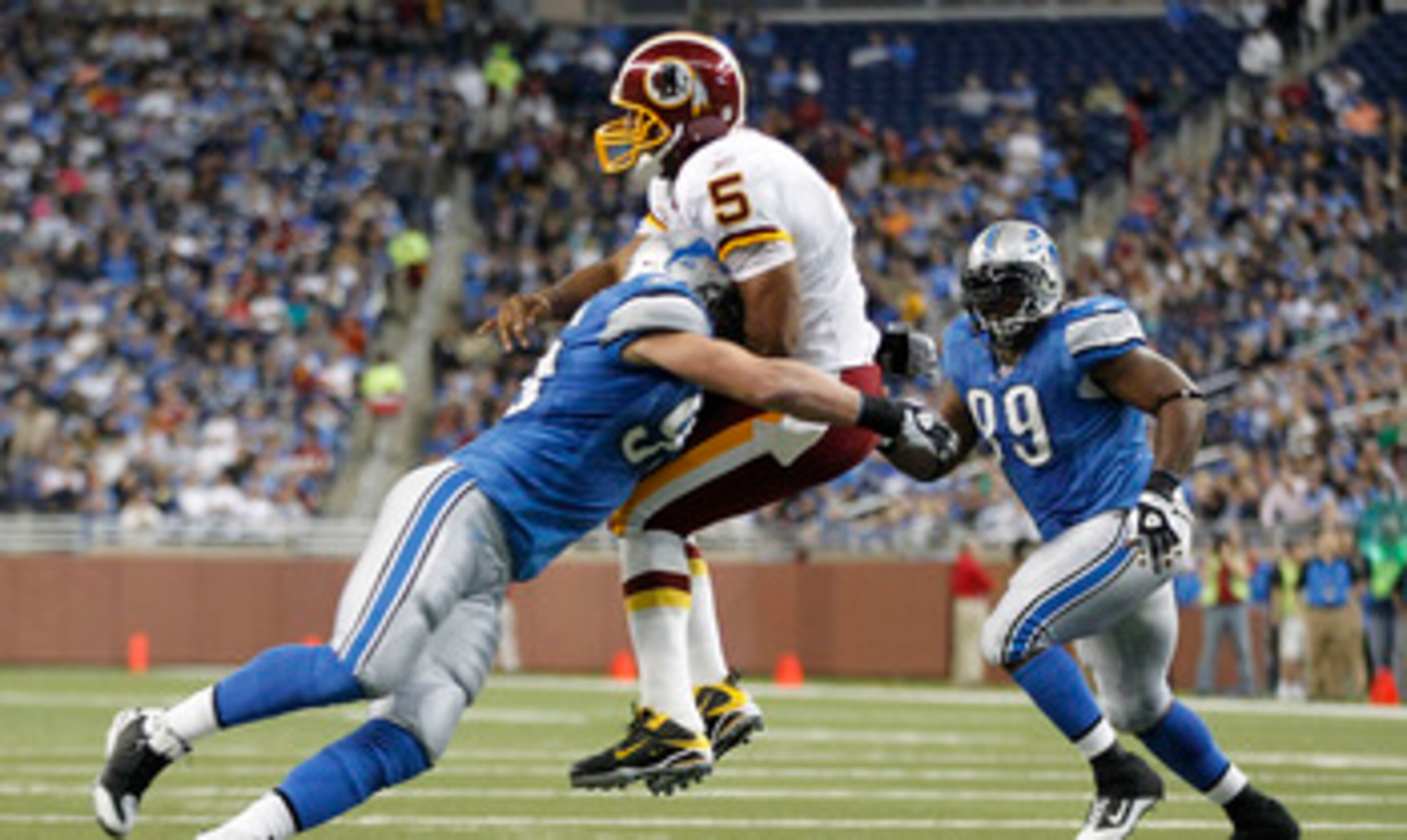 DETROIT - OCTOBER 31: Kyle Vanden Bosch #93 of the Detroit Lions hits Donovan McNabb #5 of the Washington Redskins during the first quarter of the game at Ford Field on October 31, 2010 in Detroit, Michigan. (Photo by Leon Halip/Getty Images)