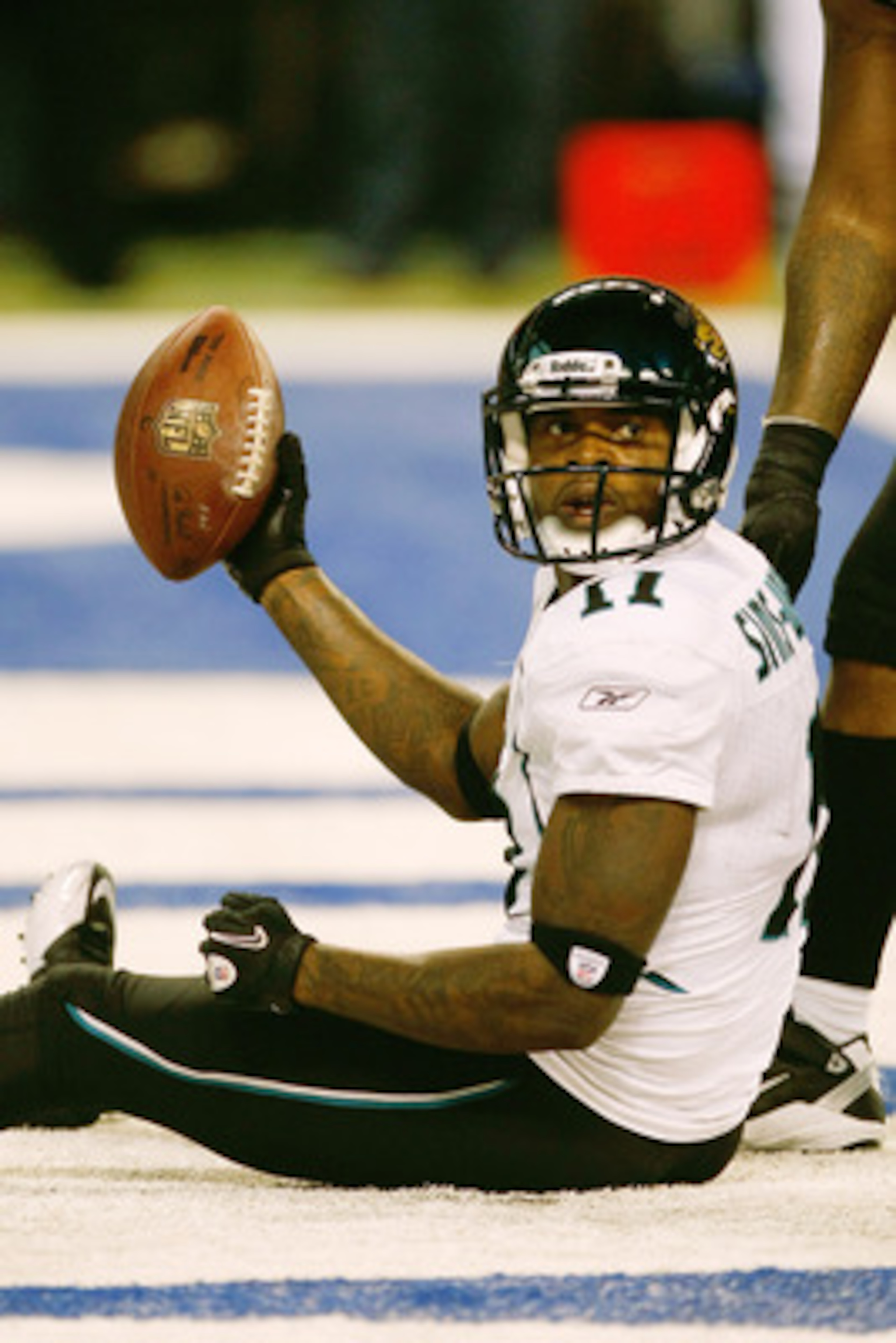 INDIANAPOLIS, IN - DECEMBER 19: Mike Sims-Walker #11 of the Jacksonville Jaguars holds up the football after scoring a touchdown against the Indianapolis Colts at Lucas Oil Stadium on December 19, 2010 in Indianapolis, Indiana. The Colts defeated the Jagu