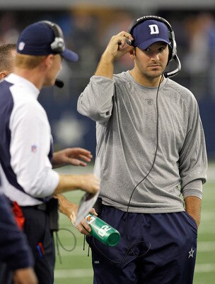 ARLINGTON, TX - NOVEMBER 21: Injured quarterback Tony Romo #9 of the Dallas Cowboys stands on the sidelines with head coach Jason Garrett at Cowboys Stadium on November 21, 2010 in Arlington, Texas. The Cowboys beat the Detroit Lions 35-19 with backup q ARLINGTON, TX - NOVEMBER 21: Injured quarterback Tony Romo #9 of the Dallas Cowboys stands on the sidelines with head coach Jason Garrett at Cowboys Stadium on November 21, 2010 in Arlington, Texas. The Cowboys beat the Detroit Lions 35-19 with backup q