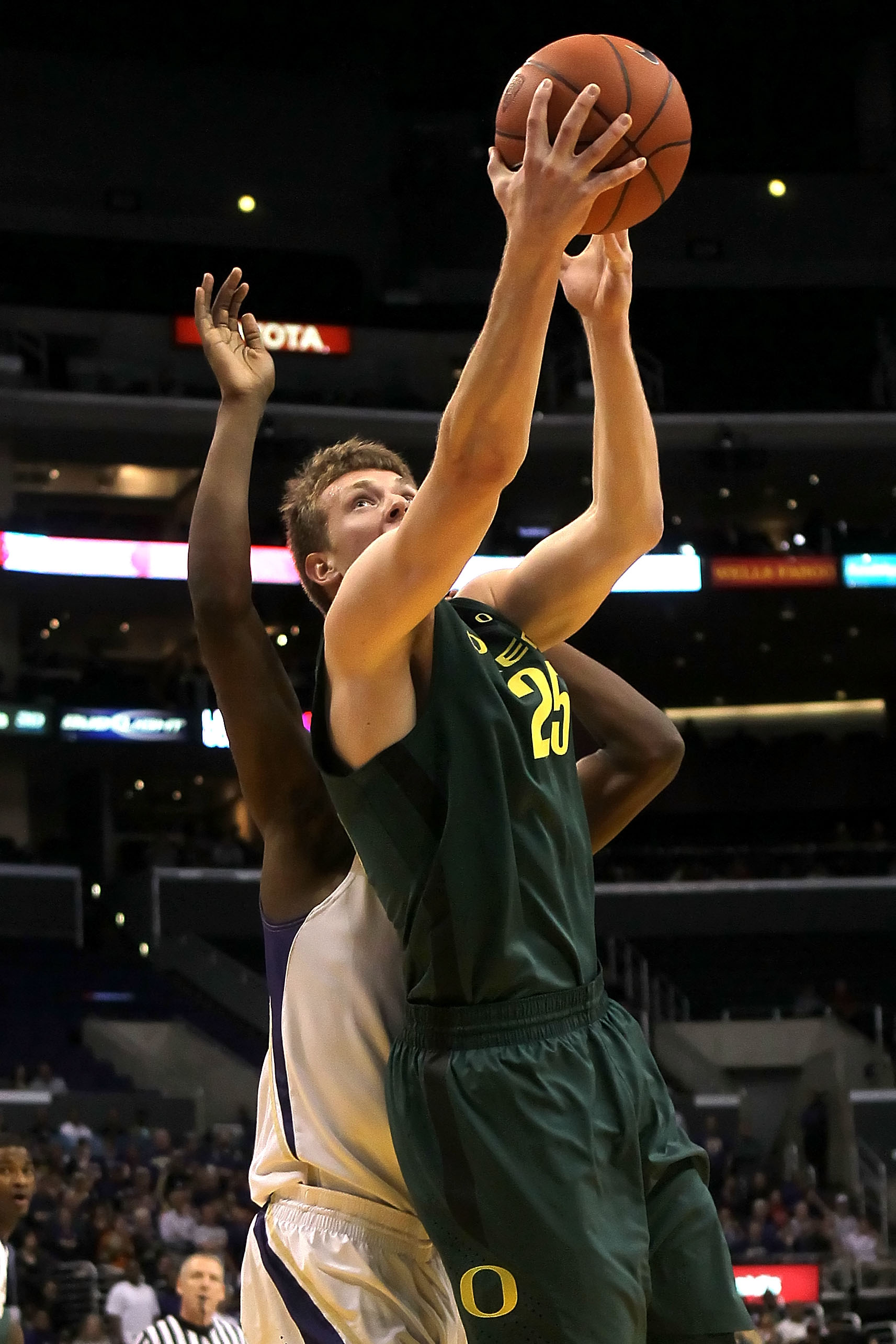 LOS ANGELES, CA - MARCH 11:  E.J. Singler #25 of the Oregon Ducks goes up for a shot in the lane in the first half against the Washington Huskies in the semifinals of the 2011 Pacific Life Pac-10 Men's Basketball Tournament at Staples Center on March 11,