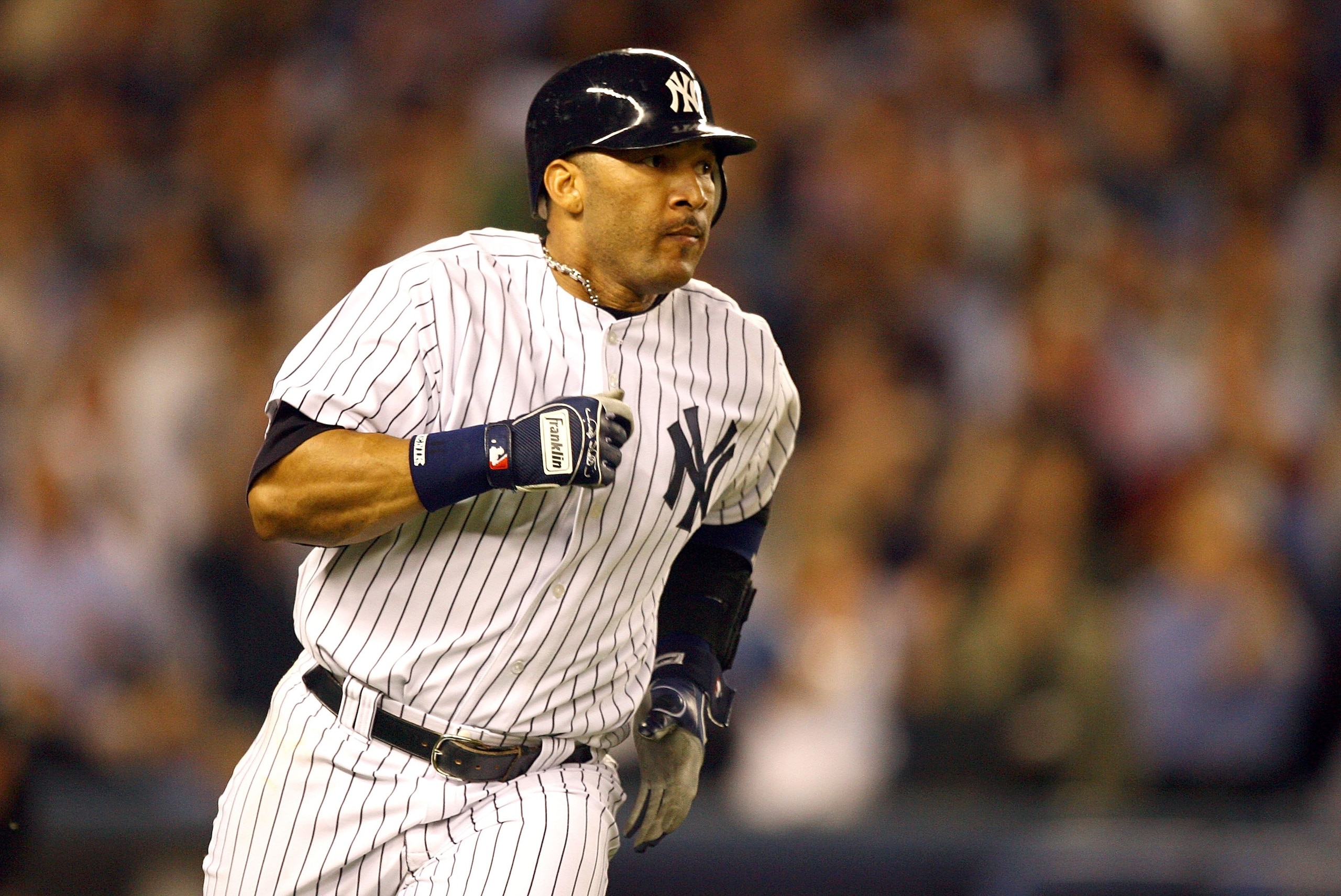 NEW YORK - OCTOBER 03:  Gary Sheffield #11 of the New York Yankees runs after hitting a single to drive in a run in the third inning against the Detroit Tigers in Game One of the American League Division Series on October 3, 2006 at Yankee Stadium in the