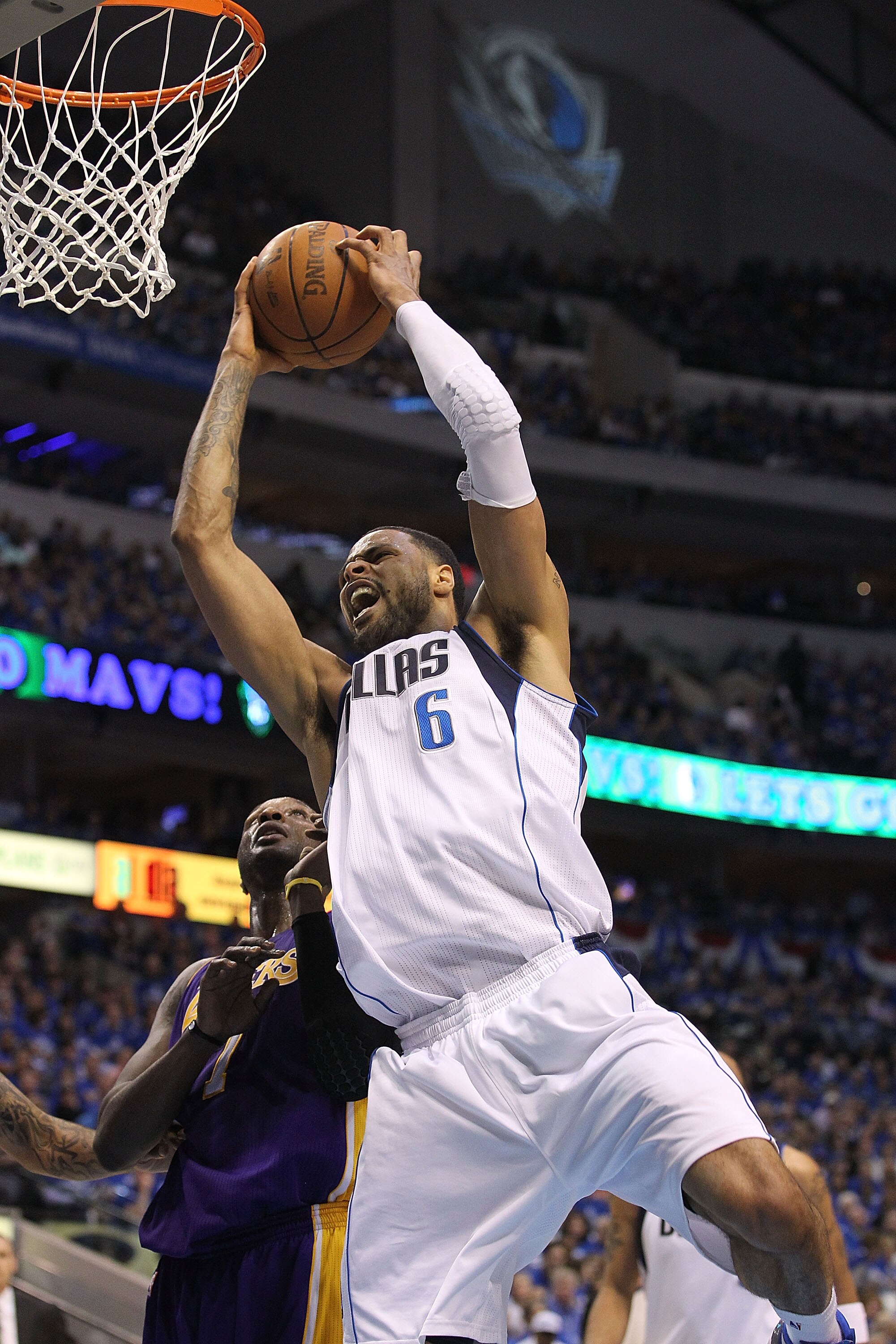 DALLAS, TX - MAY 06:  Center Tyson Chandler #6 of the Dallas Mavericks gets the slam dunk against Lamar Odom #7 of the Los Angeles Lakers in Game Three of the Western Conference Semifinals during the 2011 NBA Playoffs on May 6, 2011 at American Airlines C