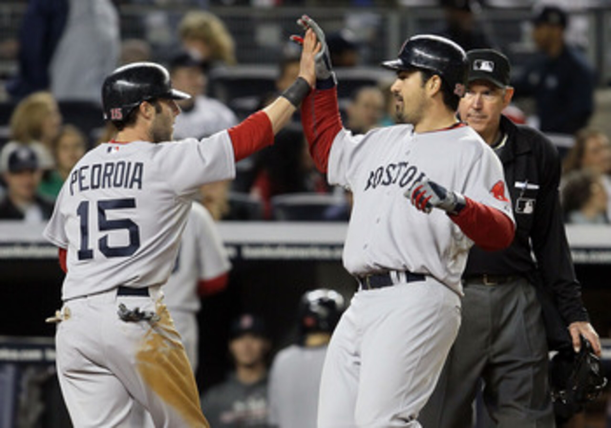 NEW YORK, NY - MAY 14:  Adrian Gonzalez #28 of the Boston Red Sox celebrates his seventh inning three run home run against the New York Yankees with teammate Dustin Pedroia #15 on May 14, 2011 at Yankee Stadium in the Bronx borough of New York City.  (Pho