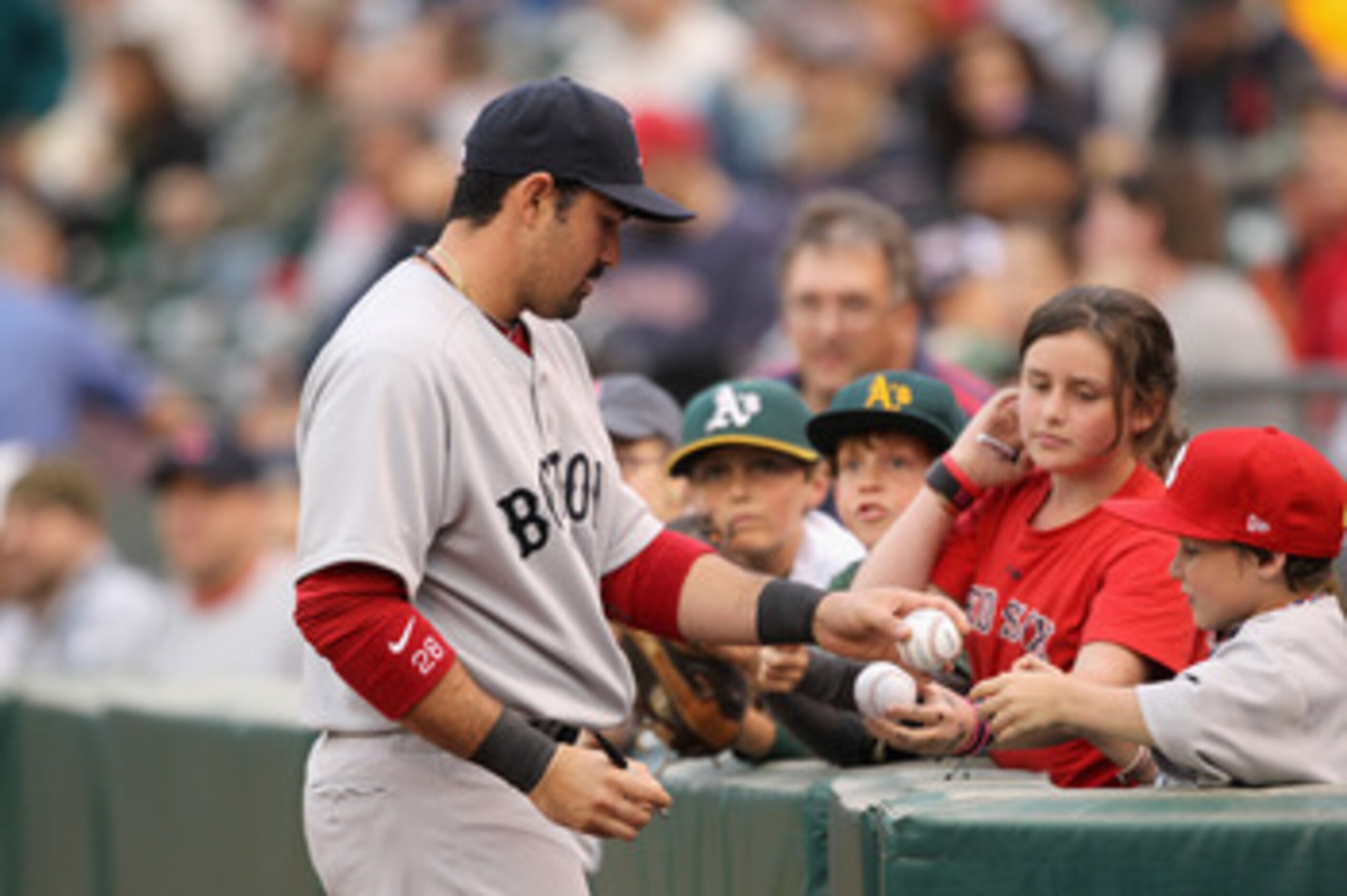 OAKLAND, CA - APRIL 19:  Adrian Gonzalez #28 of the Boston Red Sox signs autographs before their game against the Oakland Athletics at Oakland-Alameda County Coliseum on April 19, 2011 in Oakland, California.  (Photo by Ezra Shaw/Getty Images)
