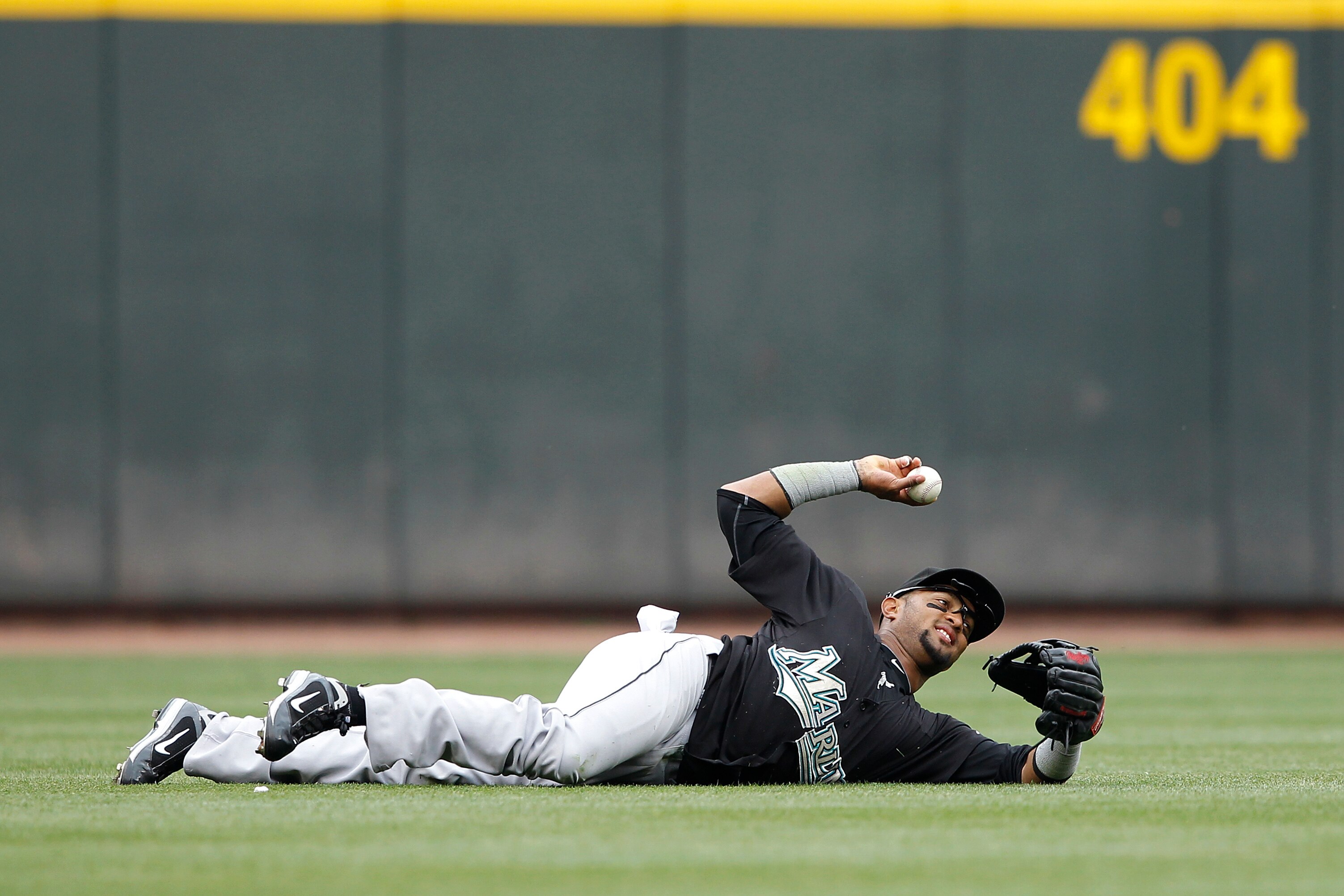 CINCINNATI, OH - MAY 1: Emilio Bonifacio #1 of the Florida Marlins throws the ball after making a diving catch against the Cincinnati Reds at Great American Ball Park on May 1, 2011 in Cincinnati, Ohio. The Marlins defeated the Reds 9-5. (Photo by Joe Rob
