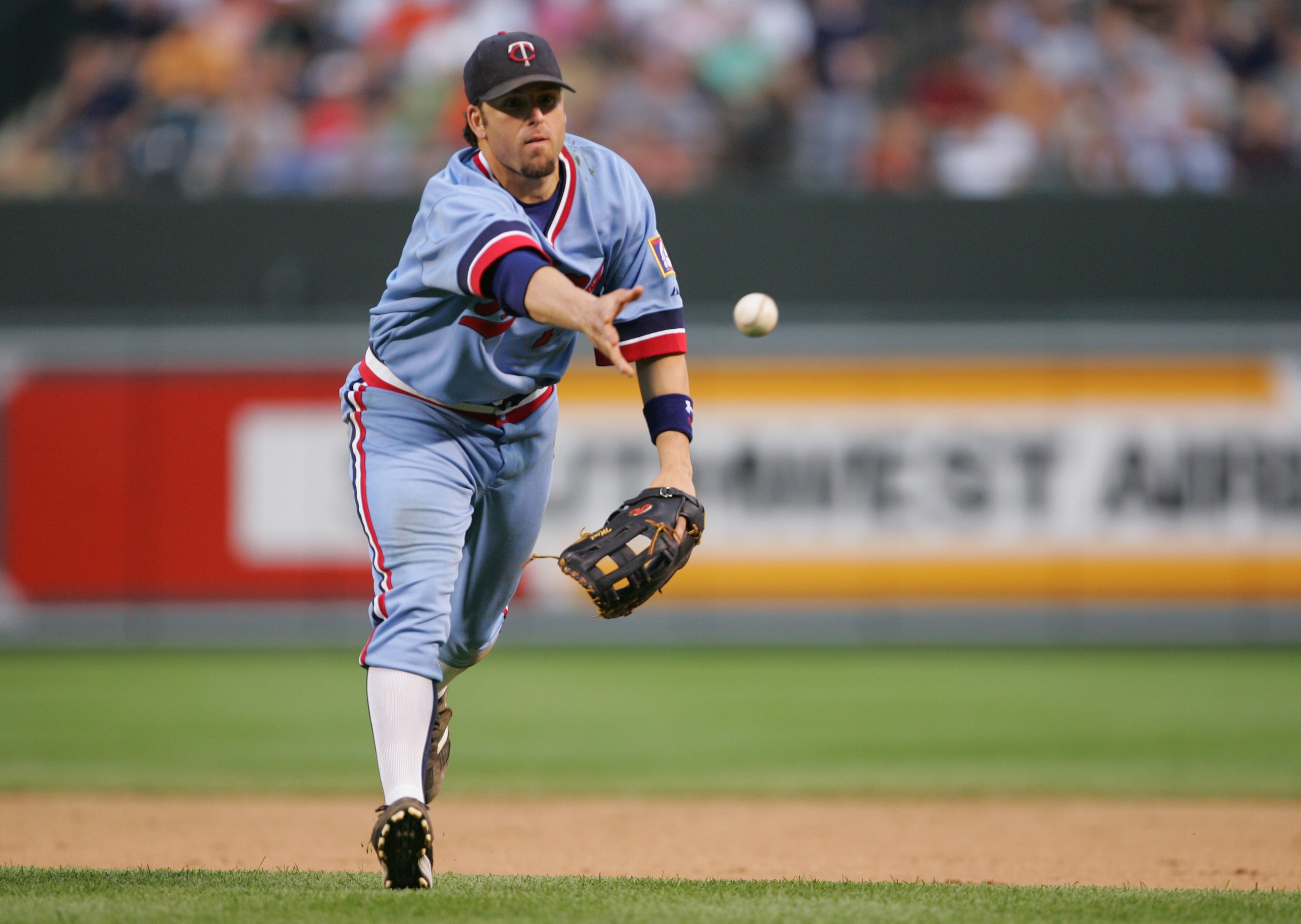 BALTIMORE - JULY 24:  Doug Mientkiewicz #13 of the Minnesota Twins tosses the ball during the game against the Baltimore Orioles at Camden Yards on July 24, 2004 in Baltimore, Maryland.  The Orioles won 4-2.  (Photo by Jamie Squire/Getty Images)