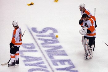 BOSTON, MA - MAY 06:  Jeff Carter #17, Brian Boucher #33, and Mike Richards #18 of the Philadelphia Flyers leave the ice following defeat at the hands of the Boston Bruins in Game Four of the Eastern Conference Semifinals during the 2011 NHL Stanley Cup P