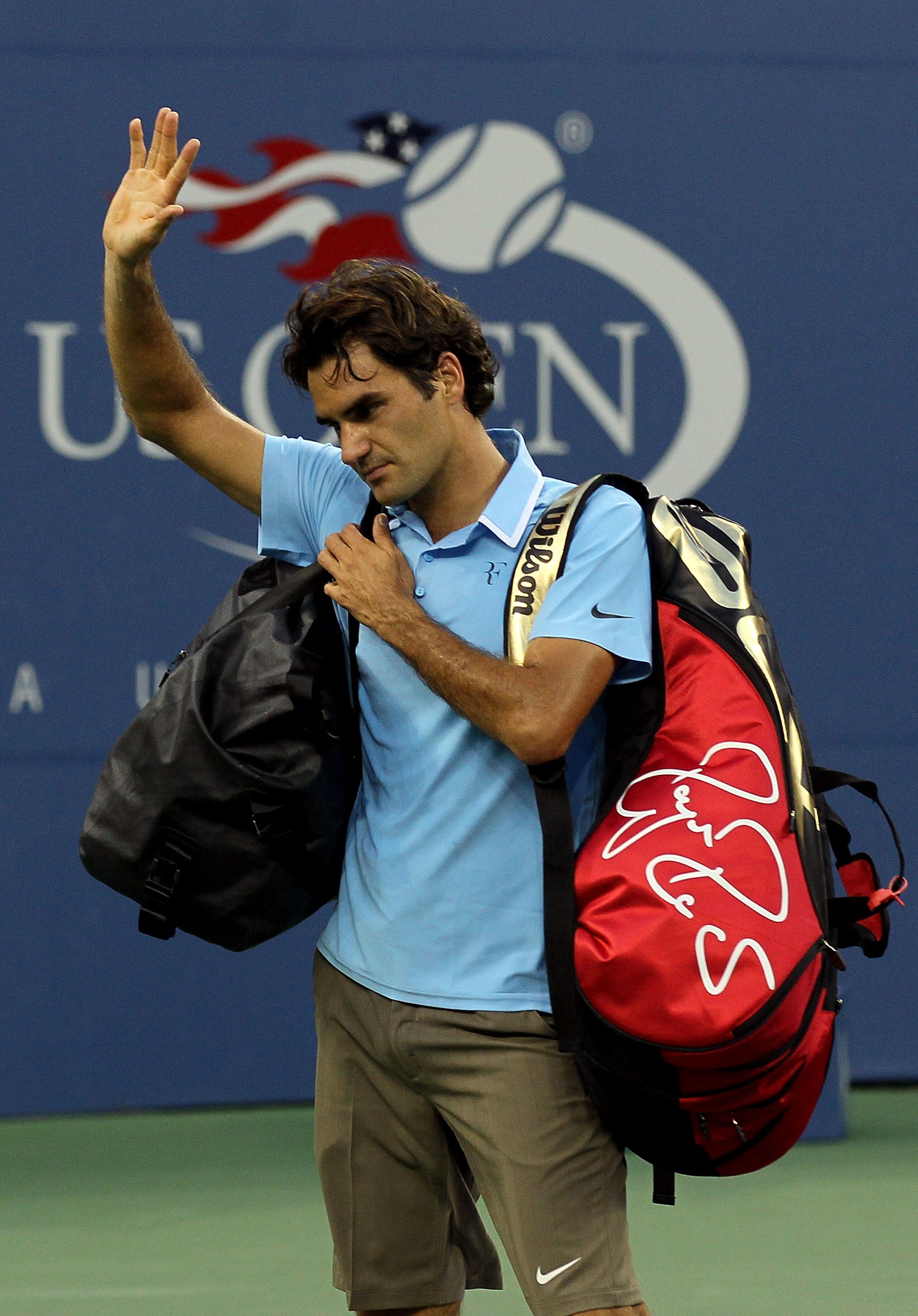 NEW YORK - SEPTEMBER 11:  Roger Federer of Switzerland waves to fans as he leaves the court after losing to Novak Djokovic of Serbia during the men's singles semifinal match on day thirteen of the 2010 U.S. Open at the USTA Billie Jean King National Tenni