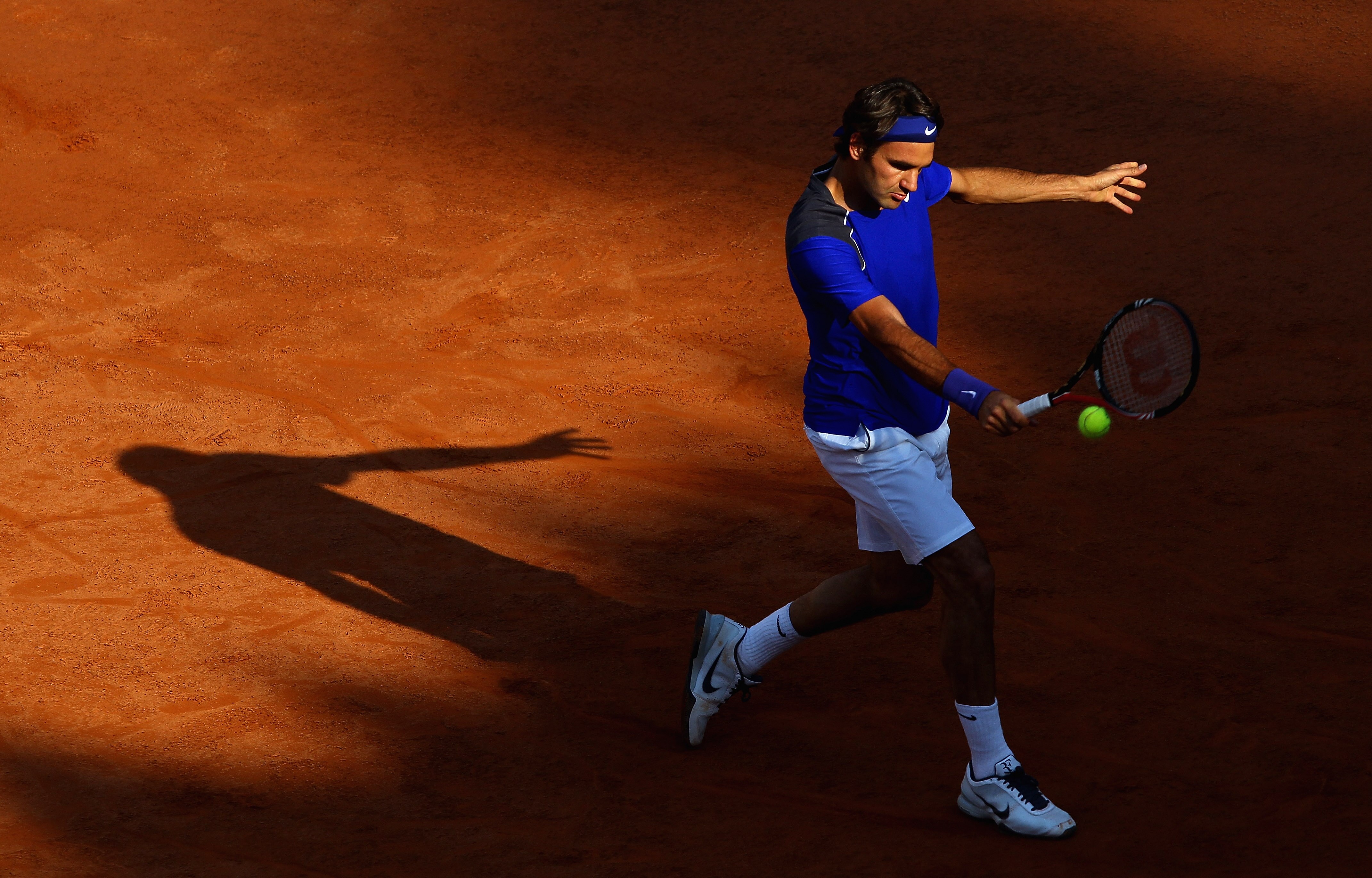 ROME, ITALY - MAY 12:  Roger Federer of Switzerland plays a backhand during his third round match against Richard Gasquet of France during day five of the Internazoinali BNL D'Italia at the Foro Italico Tennis Centre on May 12, 2011 in Rome, Italy.  (Phot