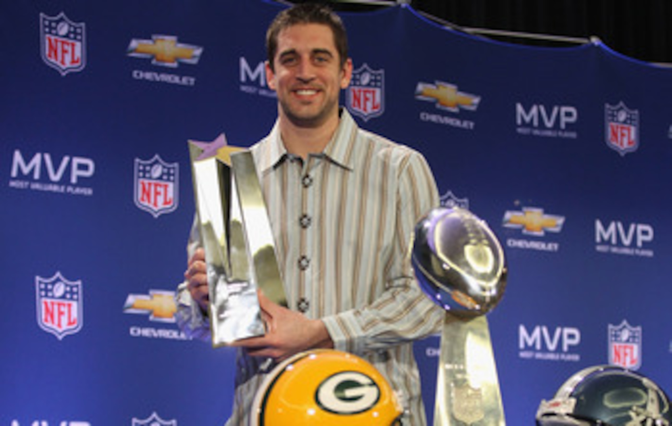 DALLAS, TX - FEBRUARY 07:  Green Bay Packers quarterback Aaron Rodgers poses with the MVP trophy after speaking to the media during a press conference at Super Bowl XLV Media Center on February 7, 2011 in Dallas, Texas.  (Photo by Streeter Lecka/Getty Ima