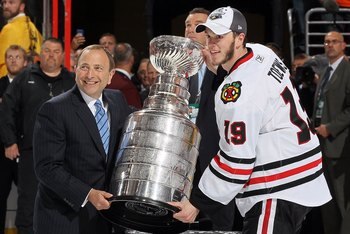 PHILADELPHIA - JUNE 09: NHL Commissioner Gary Bettman presents Jonathan Toews #19 of the Chicago Blackhawks with the Stanley Cup after teammate Patrick Kane scored the game-winning goal in overtime to defeat the Philadelphia Flyers 4-3 and win the Stanley