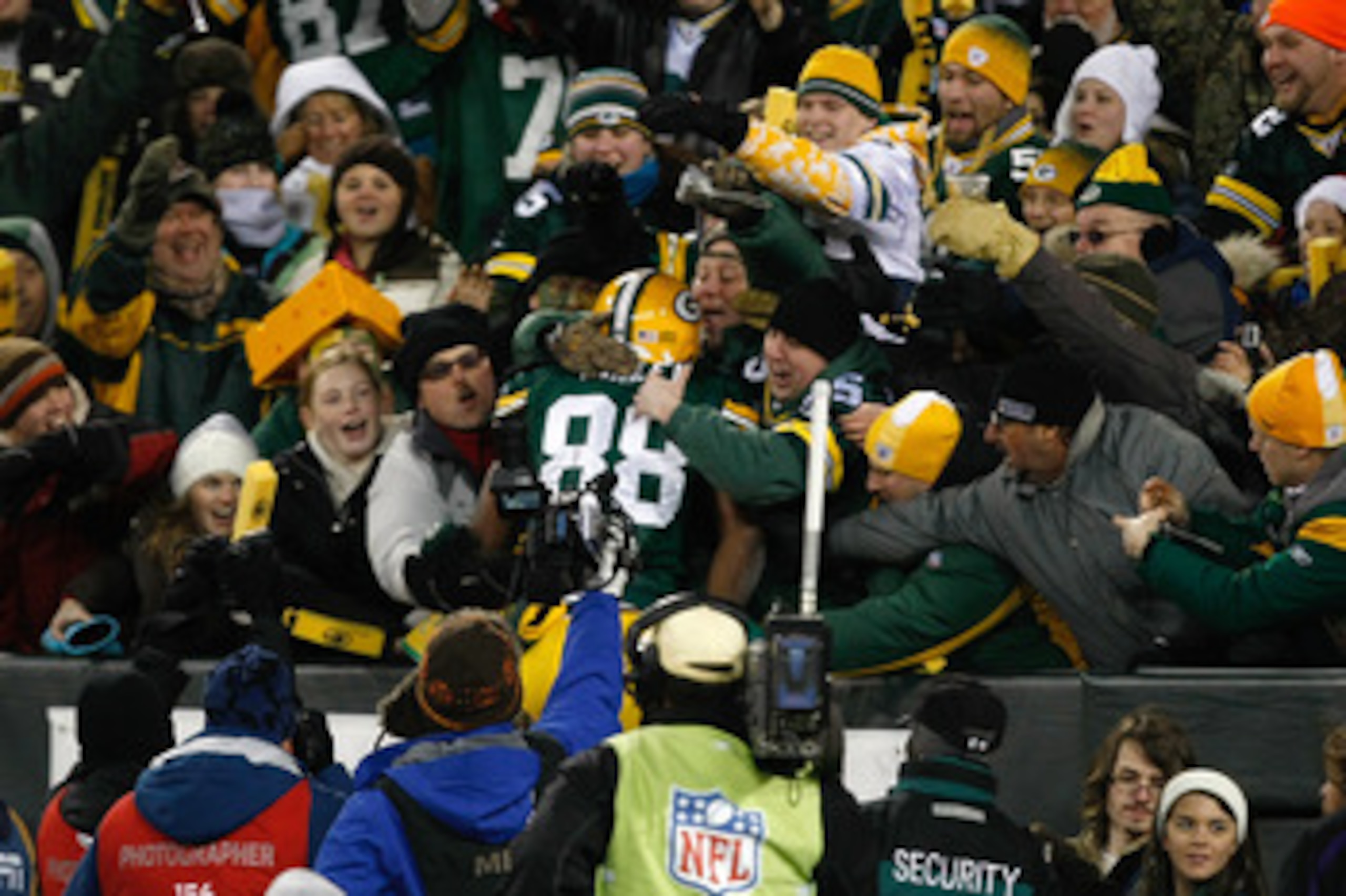 GREEN BAY, WI - DECEMBER 7:  Tight end Jermichael Finley #88 of the Green Bay Packers celebrates a touchdown by jumping in the stands with fans for a Lambeau leap in the first half against the Baltimore Ravens at Lambeau Field on December 7, 2009 in Green
