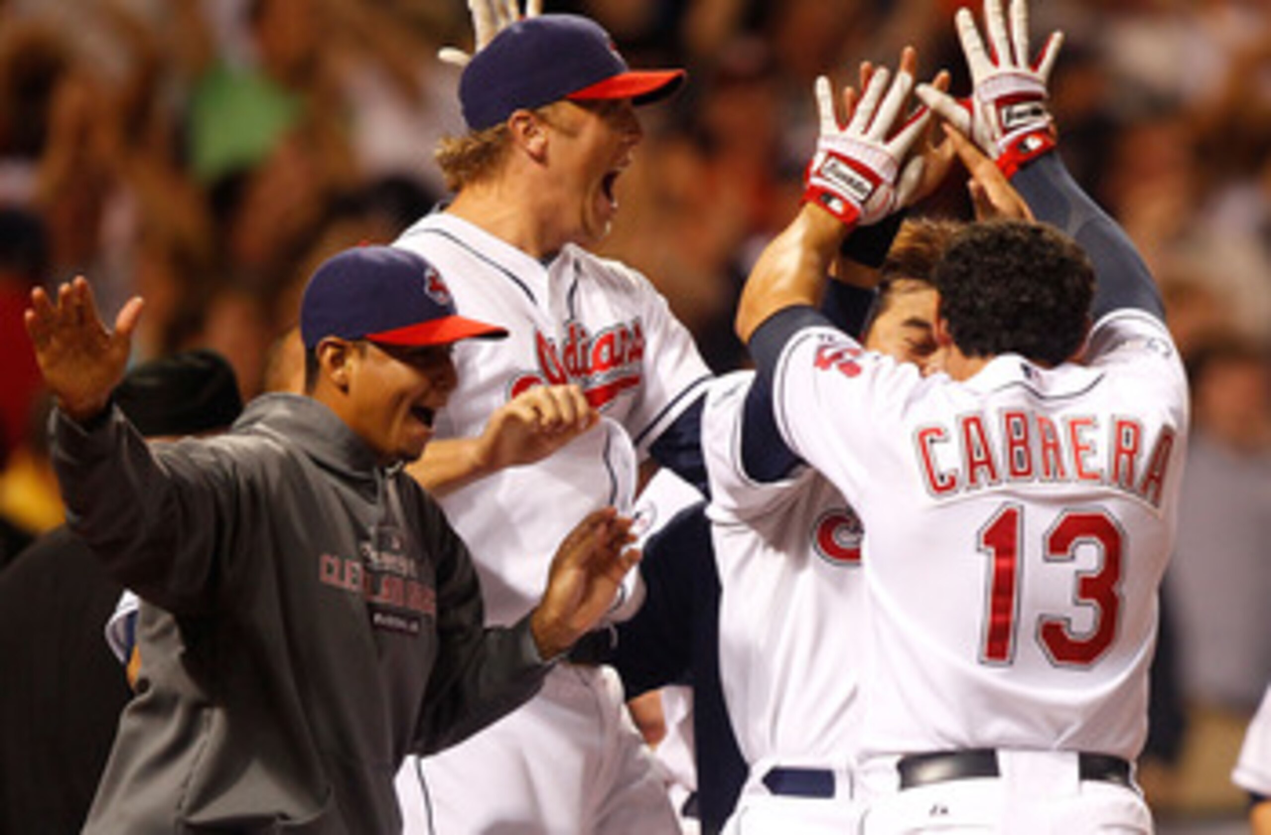 CLEVELAND - MAY 13:  Shin-Soo Choo #17, Asdrubal Cabrera #13, and Shelley Duncan #47 of the Cleveland Indians celebrate following the walk-off two run home run by Travis Hafner #48 against the Seattle Mariners during the game on May 13, 2011 at Progressiv