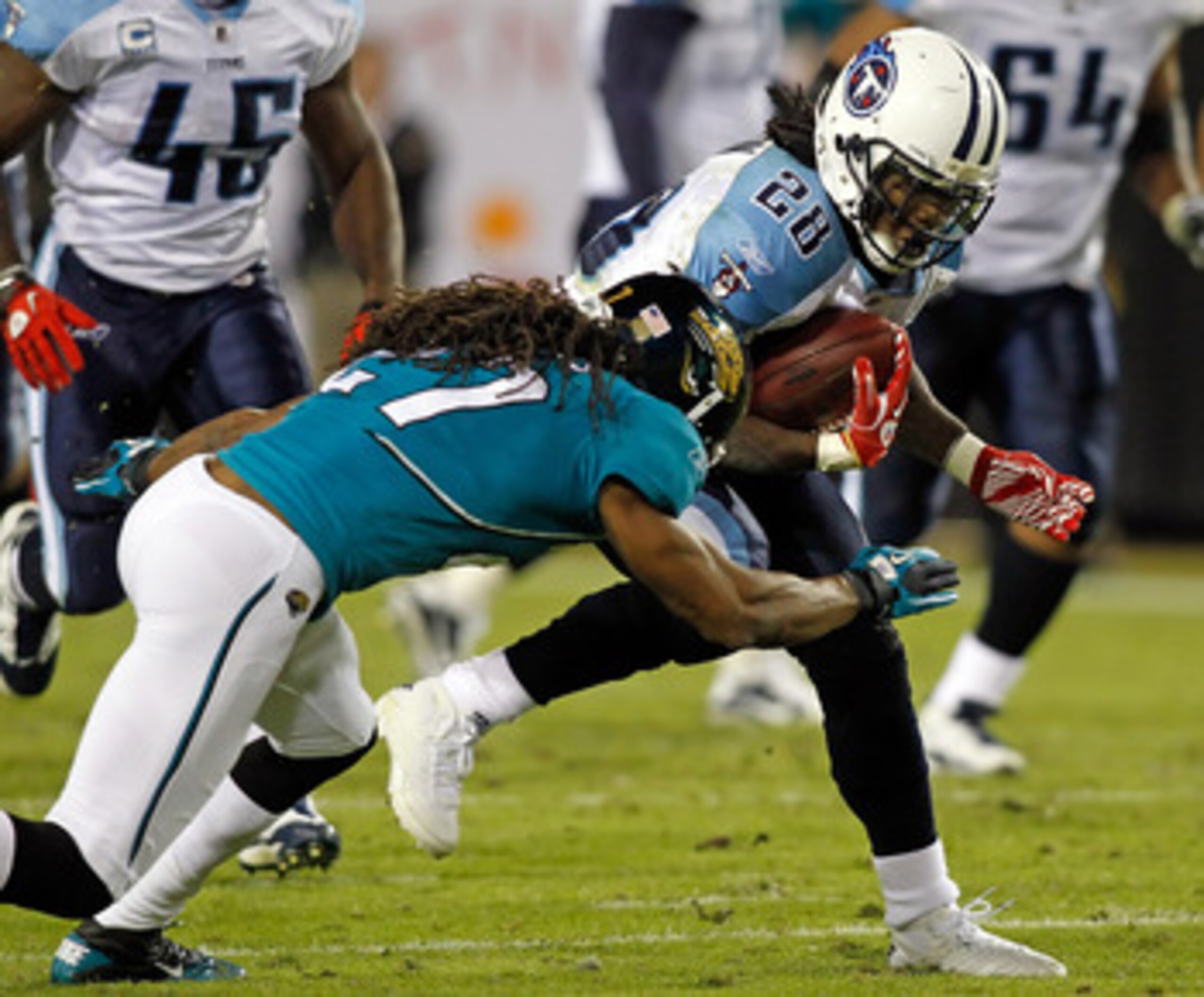JACKSONVILLE, FL - OCTOBER 18:  Running back Chris Johnson #28 of the Tennessee Titans is tackled by defensive back Rashean Mathis #27 of the Jacksonville Jaguars during the game at EverBank Field on October 18, 2010 in Jacksonville, Florida.  (Photo by J