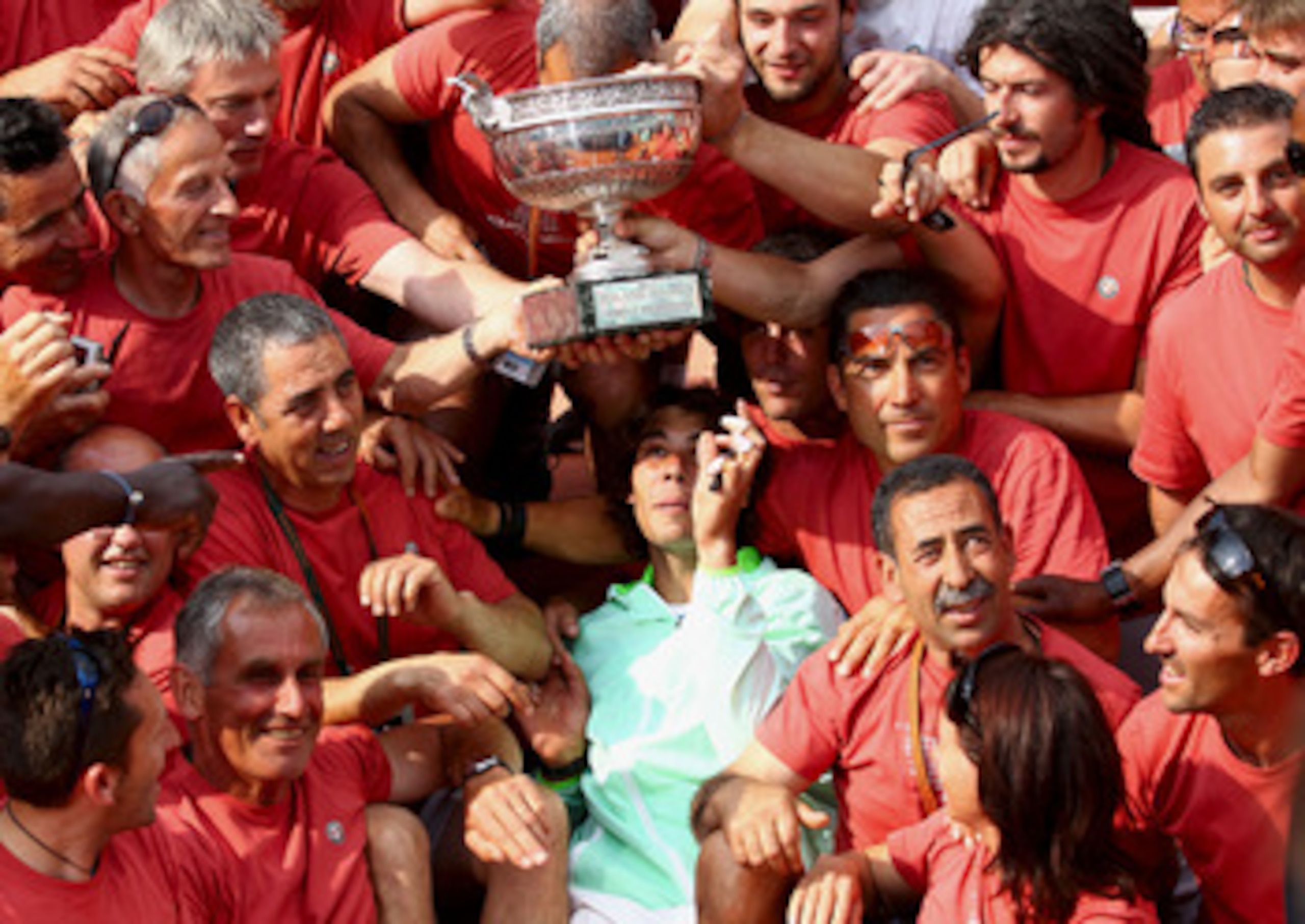 PARIS - JUNE 06:  Rafael Nadal of Spain celebrates with Roland Garros staff after winning the men's singles final match between Rafael Nadal of Spain and Robin Soderling of Sweden on day fifteen of the French Open at Roland Garros on June 6, 2010 in Paris