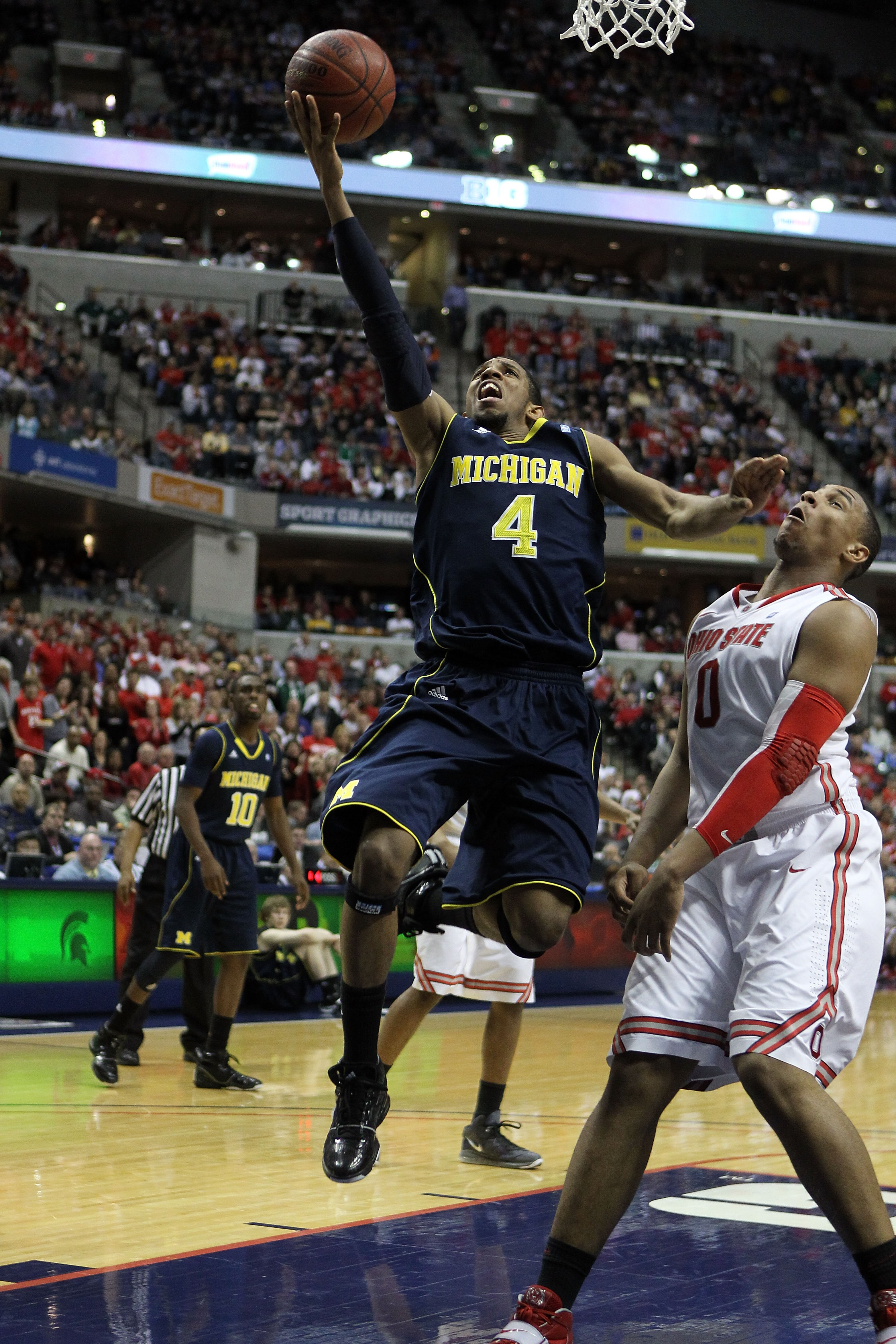 INDIANAPOLIS, IN - MARCH 12:  Darius Morris #4 of the Michigan Wolverines attempts a shot against Jared Sullinger #0 of the Ohio State Buckeyes during the semifinals of the 2011 Big Ten Men's Basketball Tournament at Conseco Fieldhouse on March 12, 2011 i