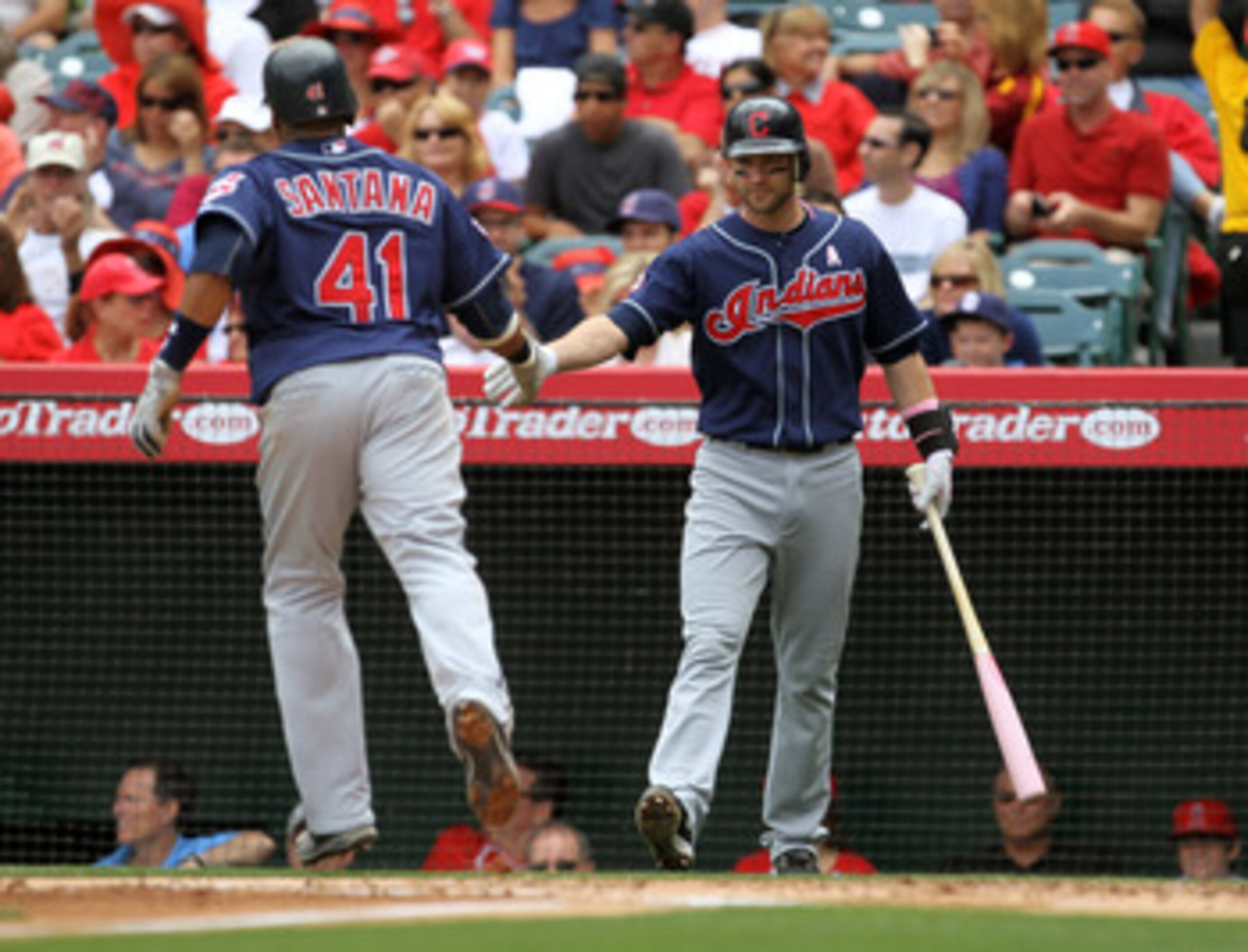 ANAHEIM, CA - MAY 8: Carlos Santana #41 of the Cleveland Indians is greeted by on deck hitter Adam Everett #8 as he scores in the second inning against the Los Angeles Angels of Anaheim on May 8, 2011 at Angel Stadium in Anaheim, California.  (Photo by St