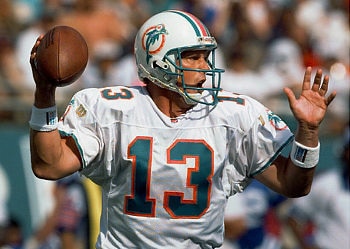 MIAMI - 1986:  Quarterback Dan Marino #13 of the Miami Dolphins smiles as he holds the ball during a game against the Atlanta Falcons in 1986 at Pro Player Stadium in Miami, Florida.  Falcons won 20-14.  (Photo by Bob Martin/Getty Images)
