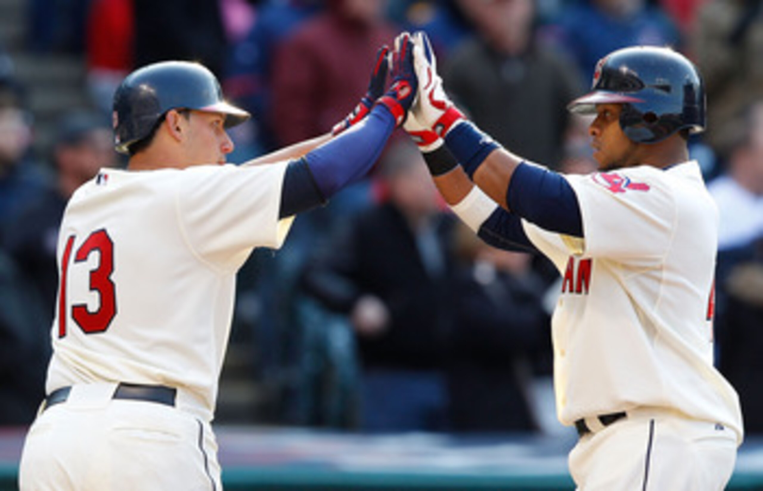 CLEVELAND - APRIL 01:  Carlos Santana #41 and Asdrubal Cabrera #13 of the Cleveland Indians celebrate after scoring against the Chicago White Sox during the Opening Day game on April 1, 2011 at Progressive Field in Cleveland, Ohio.  (Photo by Jared Wicker