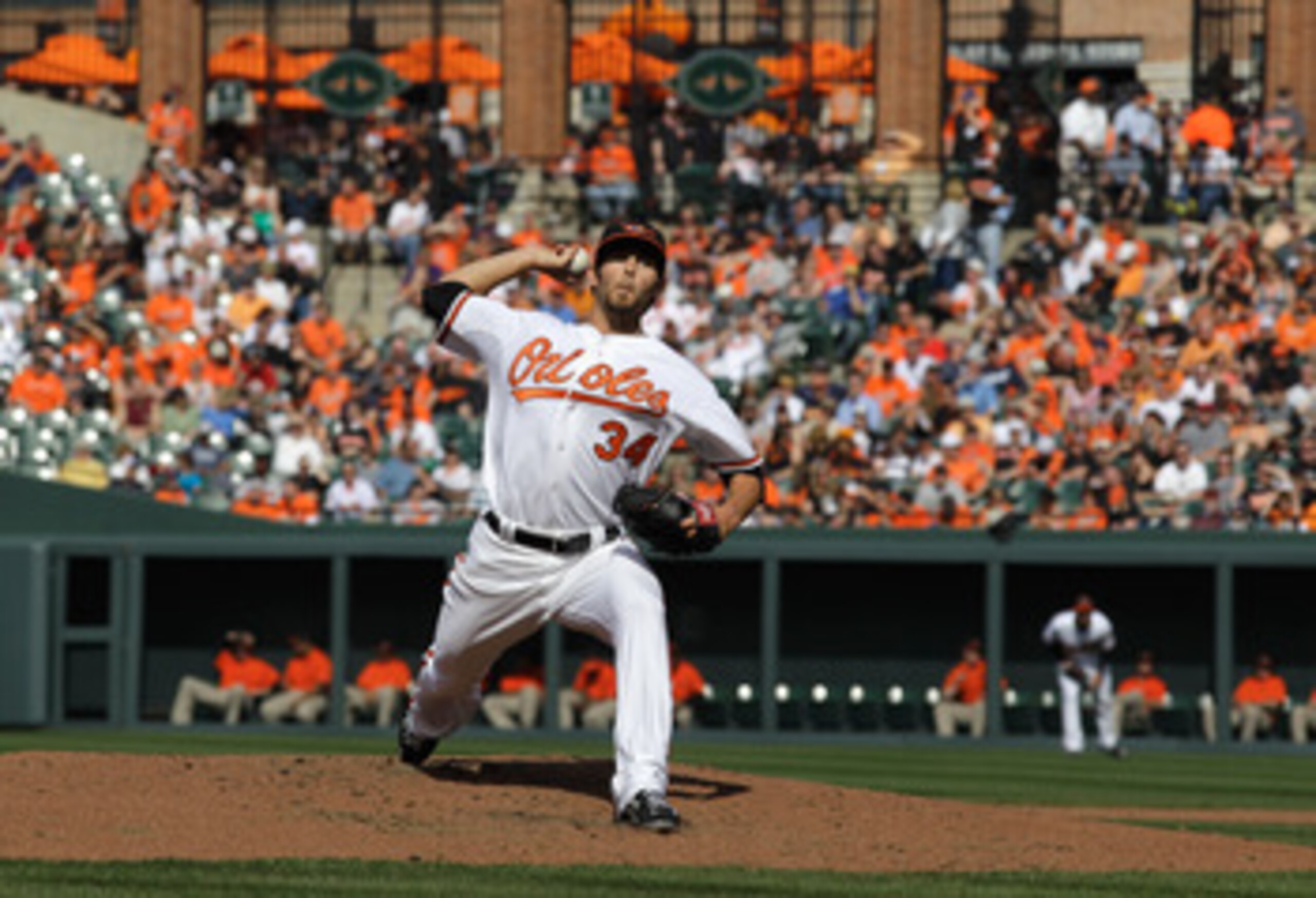 BALTIMORE, MD - APRIL 04:  Starting pitcher Jake Arrieta #34 of the Baltimore Orioles delivers to a Detroit Tigers batter during the second inning during opening day at Oriole Park at Camden Yards on April 4, 2011 in Baltimore, Maryland.  (Photo by Rob Ca
