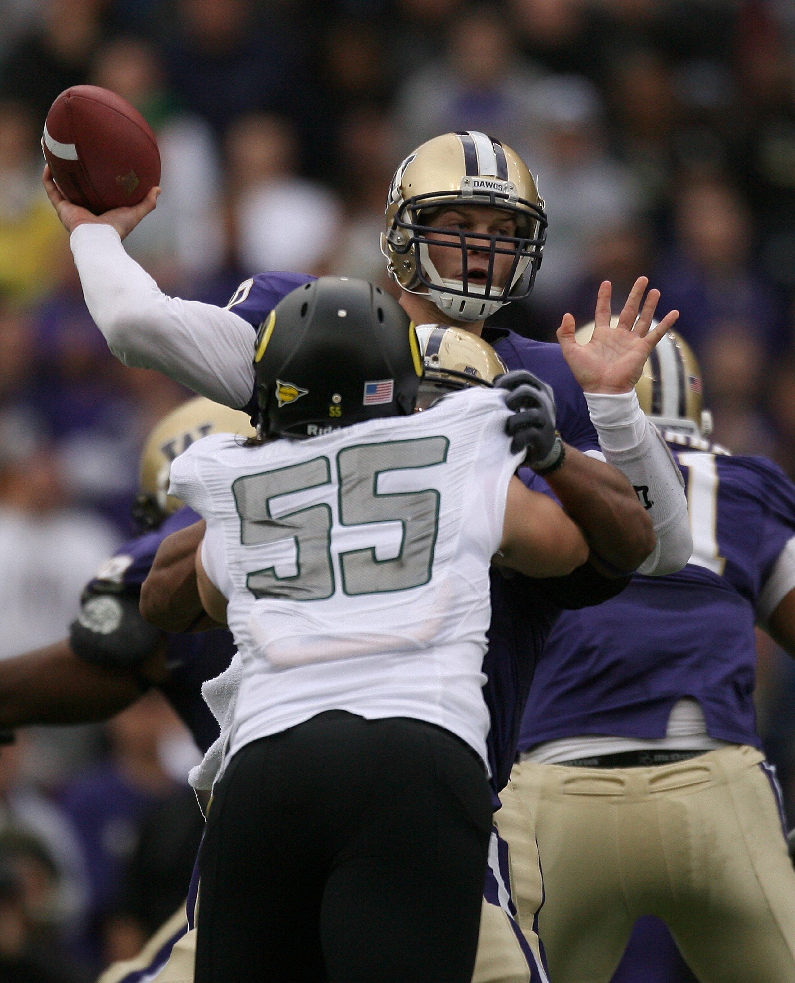 SEATTLE - OCTOBER 24:  Quarterback Jake Locker #10 of the Washington Huskies passes under pressure from Casey Matthews #55 of the Oregon Ducks on October 24, 2009 at Husky Stadium in Seattle, Washington. (Photo by Otto Greule Jr/Getty Images)