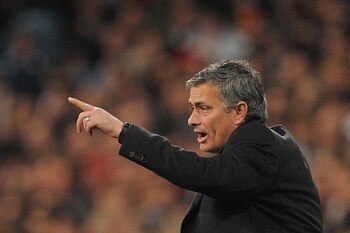 MADRID, SPAIN - MARCH 16:  Head coach Jose Mourinho of Real Madrid instructs Angel di Maria  during the UEFA Champions League round of 16 second leg match between Real Madrid and Lyon at Estadio Santiago Bernabeu on March 16, 2011 in Madrid, Spain.  (Phot