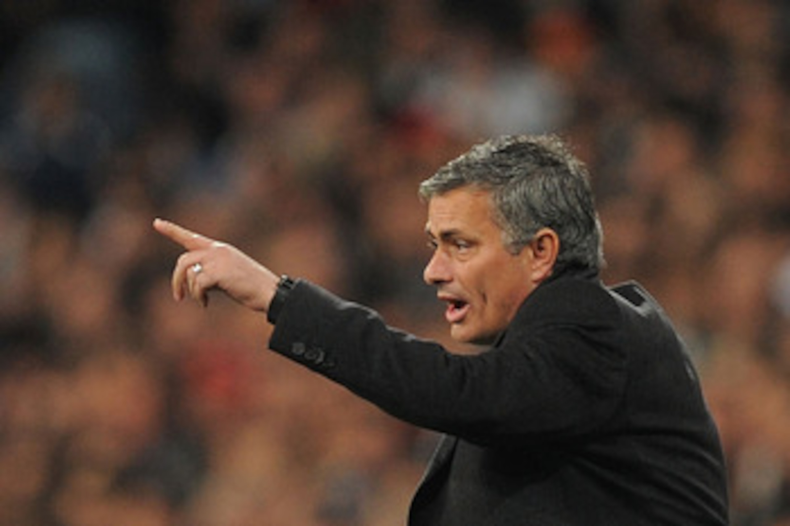 MADRID, SPAIN - MARCH 16:  Head coach Jose Mourinho of Real Madrid instructs Angel di Maria  during the UEFA Champions League round of 16 second leg match between Real Madrid and Lyon at Estadio Santiago Bernabeu on March 16, 2011 in Madrid, Spain.  (Phot