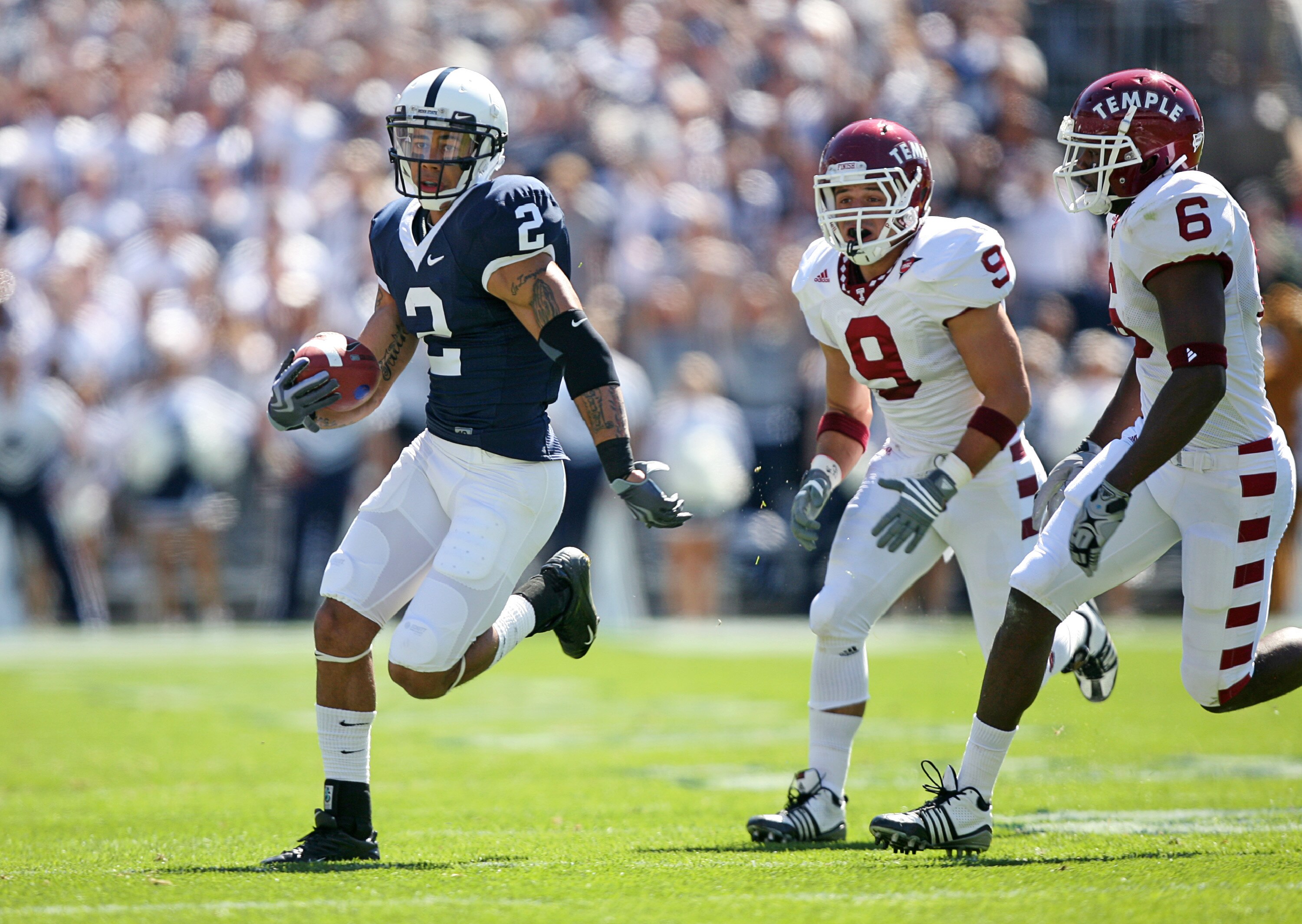 STATE COLLEGE, PA - SEPTEMBER 19: Wide receiver Chaz Powell #2 of the Penn State Nittany Lions runs with the ball after catching a pass as cornerback Anthony Ferla #9 and cornerback Dominique Harris #6 of the Temple Owls pursue during a game on September