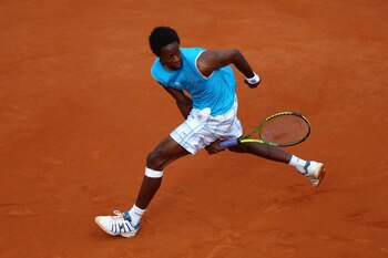 PARIS - MAY 26:  Gael Monfils of France plays through his legs during the men's singles second round match between Gael Monfils of France and Fabio Fognini of Italy at the French Open on day four of the French Open at Roland Garros on May 26, 2010 in Pari