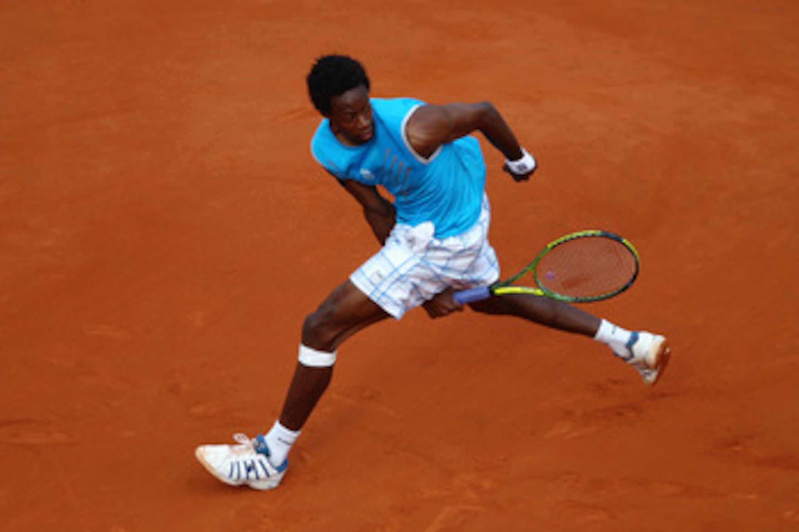 PARIS - MAY 26:  Gael Monfils of France plays through his legs during the men's singles second round match between Gael Monfils of France and Fabio Fognini of Italy at the French Open on day four of the French Open at Roland Garros on May 26, 2010 in Pari