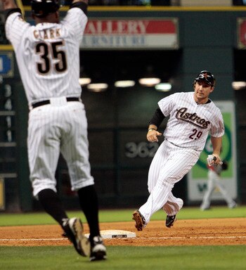 HOUSTON - MAY 09:  Brett Wallace #29 of the Houston Astros stops at third base as third base coach Dave Clark gives him the halt sign against the Cincinnati Reds at Minute Maid Park on May 9, 2011 in Houston, Texas.  (Photo by Bob Levey/Getty Images)