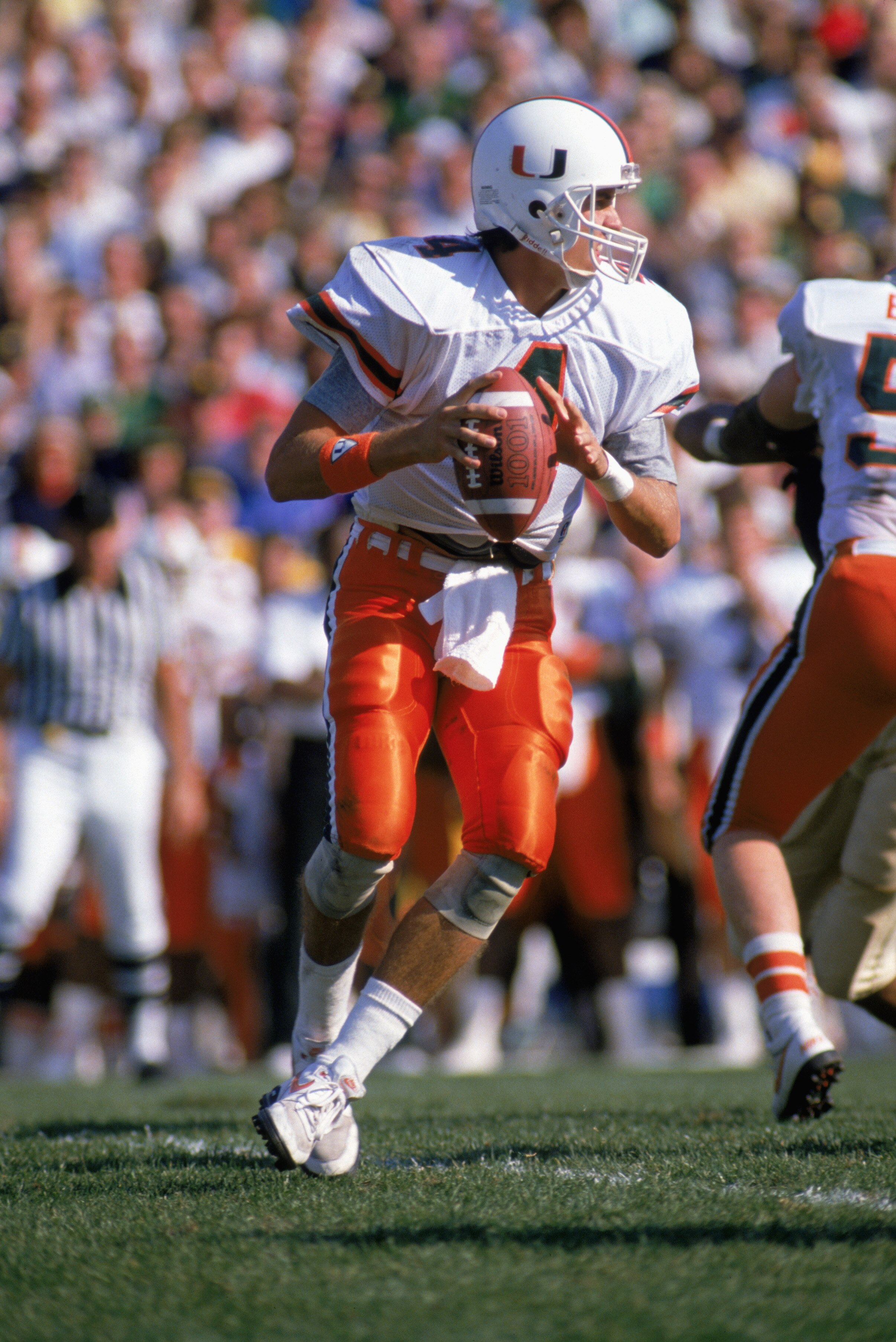 MIAMI - OCTOBER 15:   Quarterback Steve Walsh #4 of the University of Miami Hurricanes moves to pass during a game against Notre Dame Fighting Irish on October 15, 1988 in Miami, Florida. Notre Dames won 31-30. (Photo by: Jonathan Daniel/Getty Images)