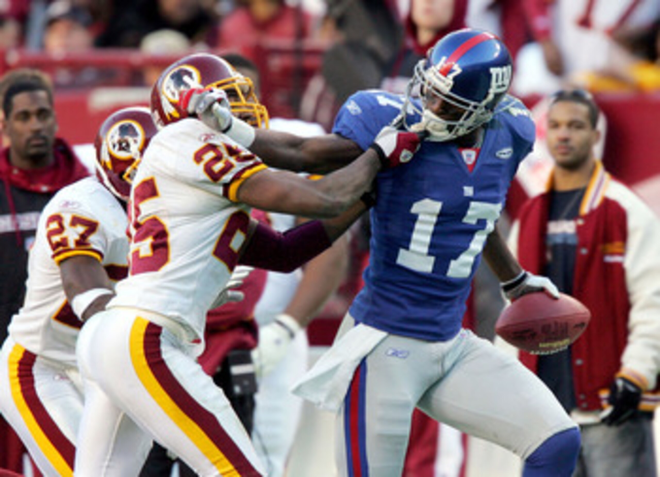 LANDOVER, MD - DECEMBER 24:  Plaxico Burress #17 of the New York Giants tries to run the ball past Ryan Clark #25 of the Washington Redskins on December 24, 2005 at FedEx Field in Landover, Maryland. The Redskins defeated the Giants 35-20. (Photo by Jim M