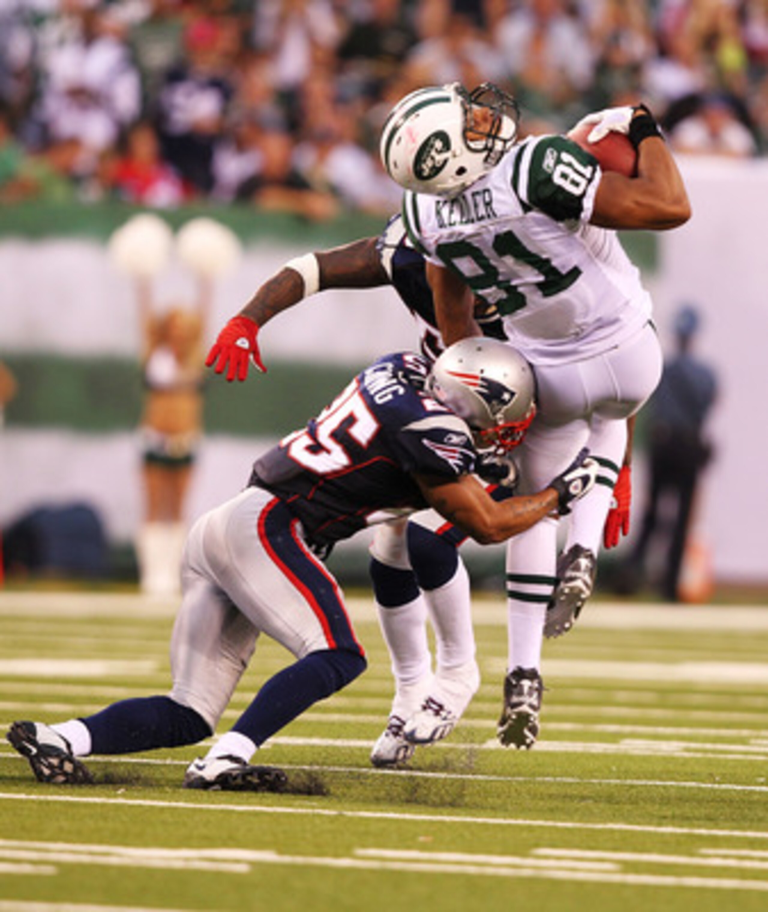 EAST RUTHERFORD, NJ - SEPTEMBER 19: Dustin Keller #81of the New York Jets is hit by Patrick Chung #25 of the New England Patriots during their game on September 19, 2010 at the New Meadowlands Stadium in East Rutherford, New Jersey. (Photo by Al Bello EAST RUTHERFORD, NJ - SEPTEMBER 19: Dustin Keller #81of the New York Jets is hit by Patrick Chung #25 of the New England Patriots during their game on September 19, 2010 at the New Meadowlands Stadium in East Rutherford, New Jersey. (Photo by Al Bello