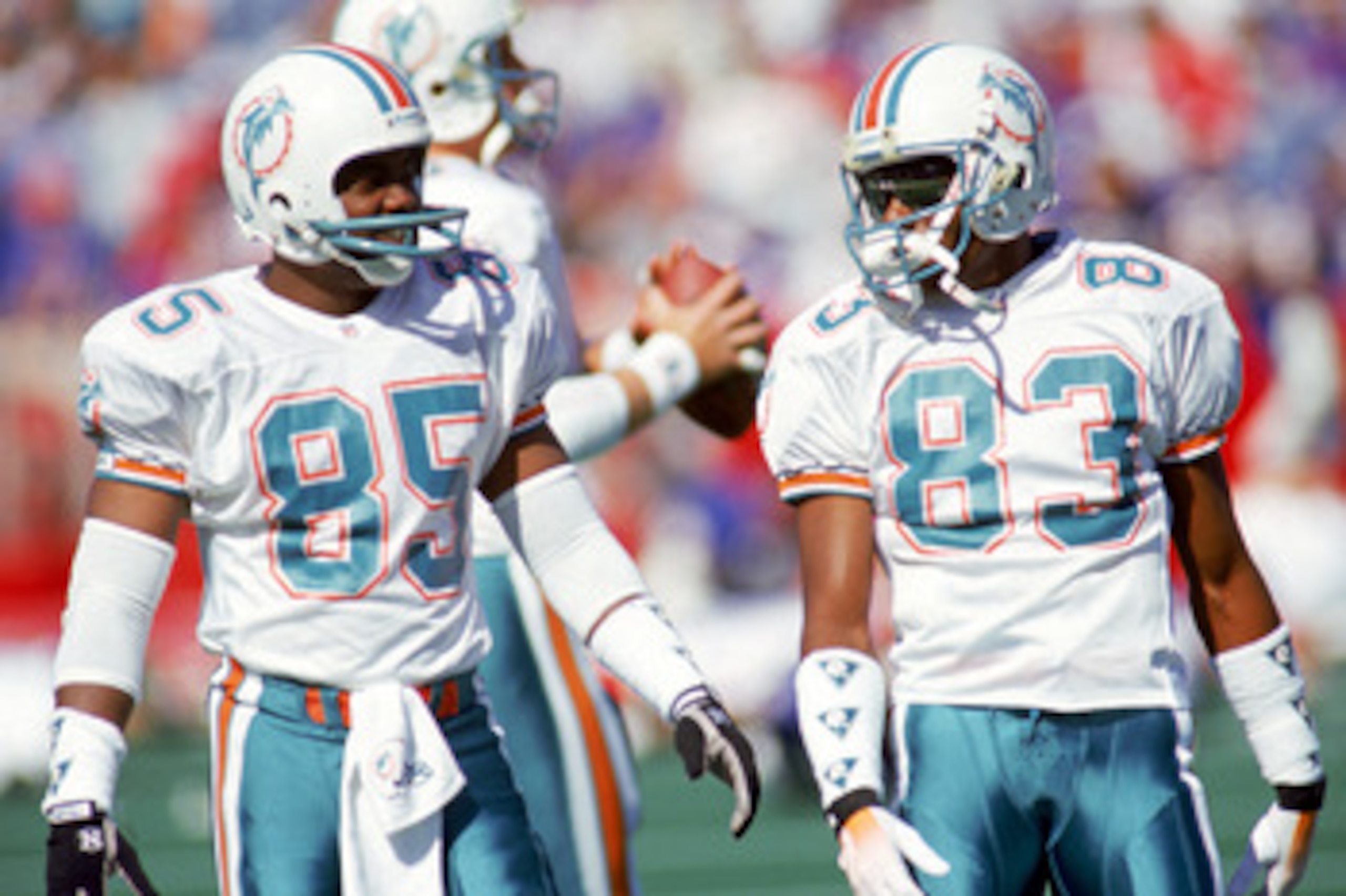 ORCHARD PARK, NY - OCTOBER 4:  Wide receiver Mark Duper #85 and Mark Clayton #83 of the Miami Dolphins talk during a game against the Buffalo Bills at Ralph Wilson Stadium on October 4, 1992 in Orchard Park, New York.  The Dolphins won 37-10.  (Photo by R