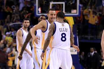 OAKLAND, CA - JANUARY 21:  Monta Ellis #8 is congratulated by Stephen Curry #30 of the Golden State Warriors after Ellis made a shot with less than a second left in regulation to send their game against the Sacramento Kings into overtime at Oracle Arena o