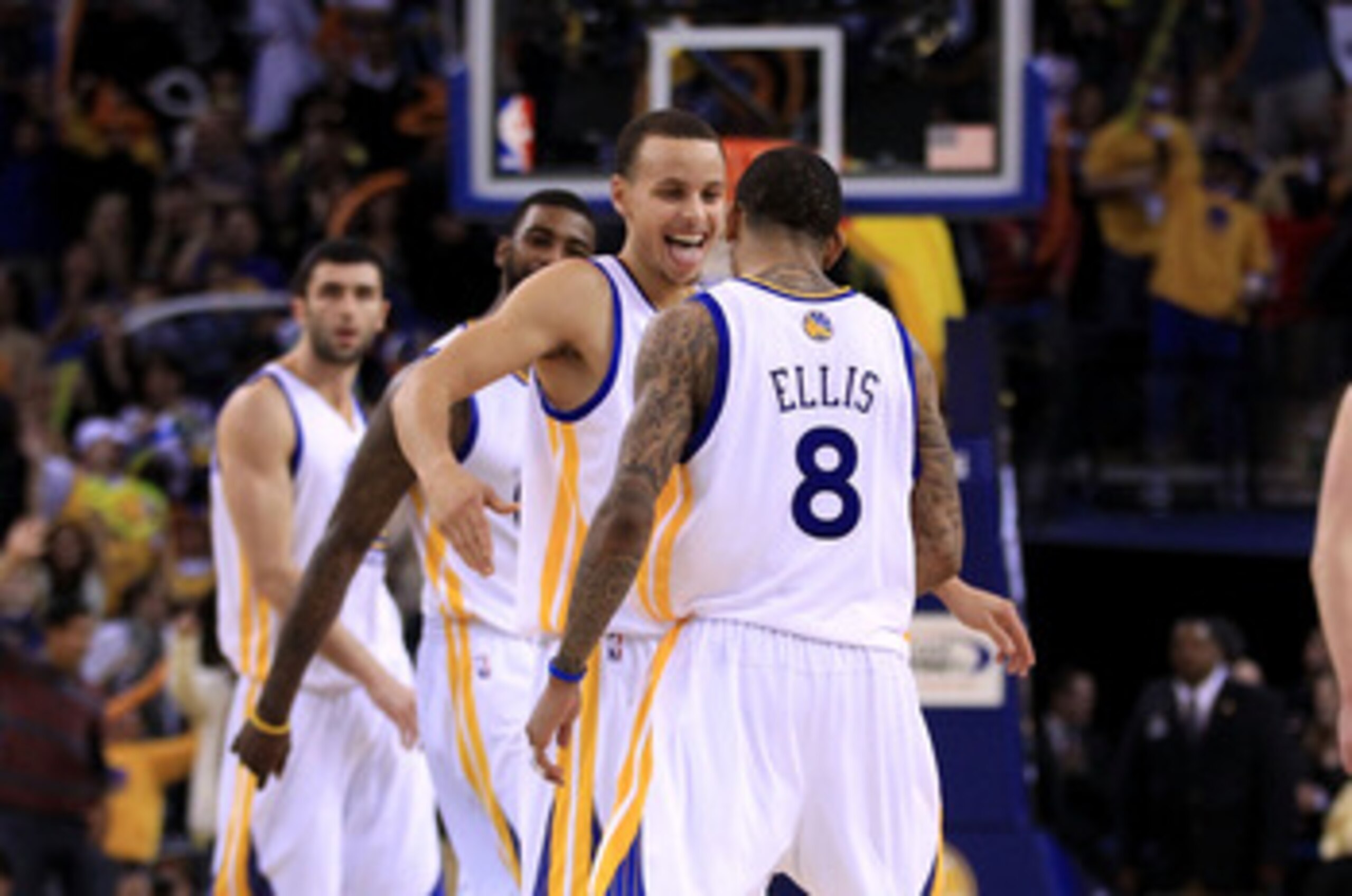 OAKLAND, CA - JANUARY 21:  Monta Ellis #8 is congratulated by Stephen Curry #30 of the Golden State Warriors after Ellis made a shot with less than a second left in regulation to send their game against the Sacramento Kings into overtime at Oracle Arena o