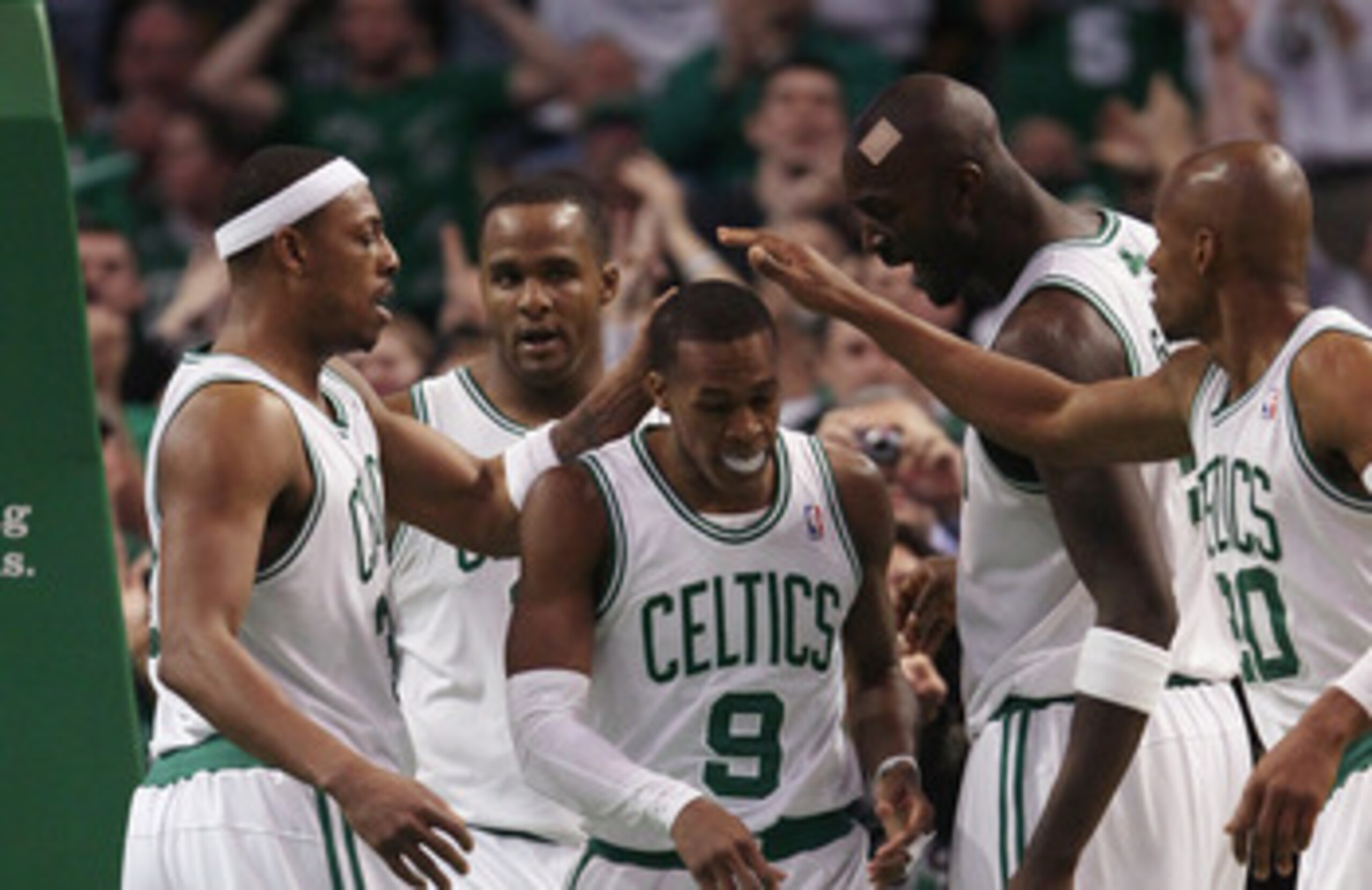 BOSTON, MA - FEBRUARY 06:  Rajon Rondo #9 of the Boston Celtics is congratulated by teammates Paul Pierce #23,Glen Davis #11,Kevin Garnett #5 and Ray Allen #20 after Rondo drew the foul in the second half agianst the Orlando Magic on February 6, 2011 at t
